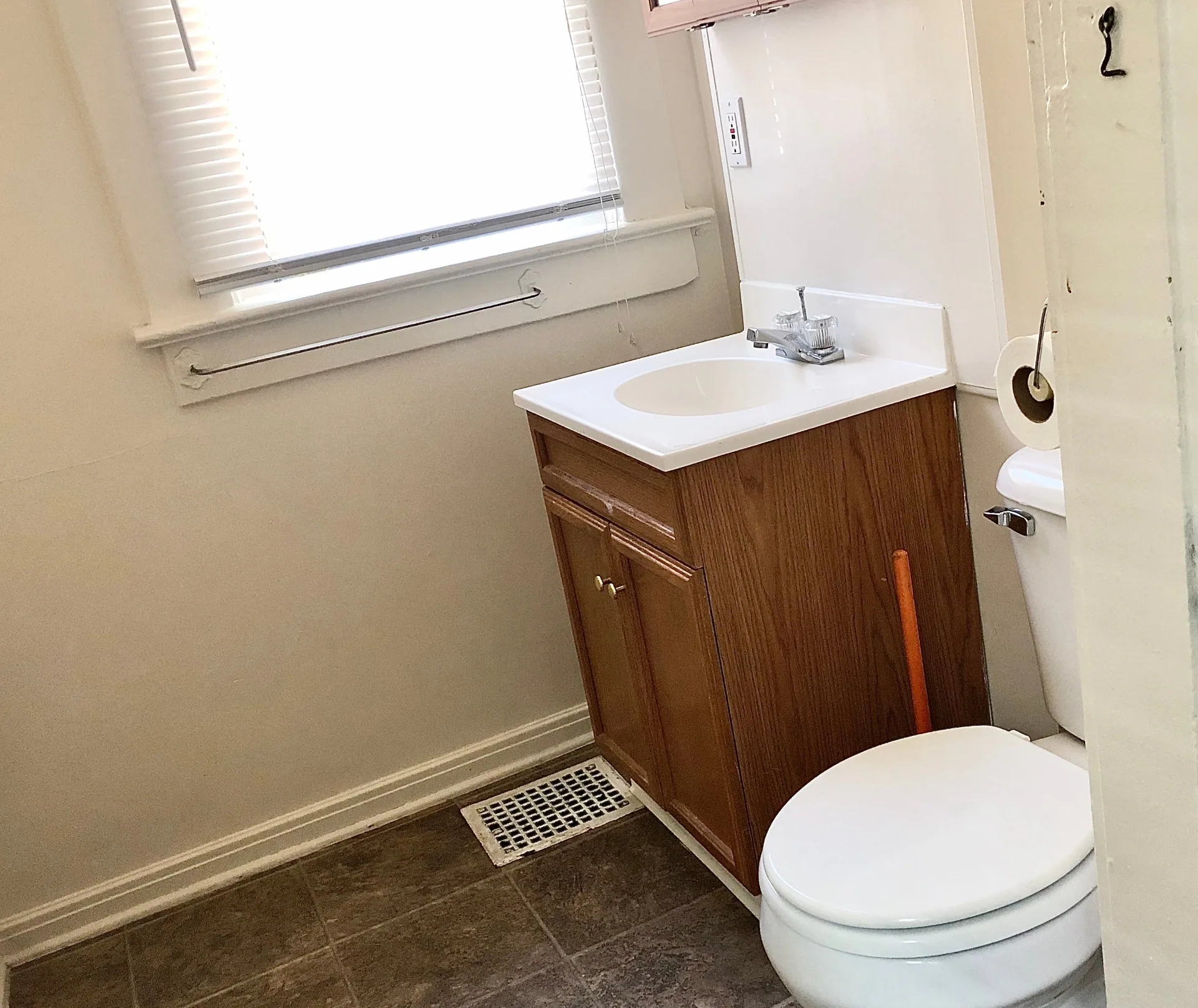 2015 Summit St. bathroom with oak vanity, tile floor, and bright window