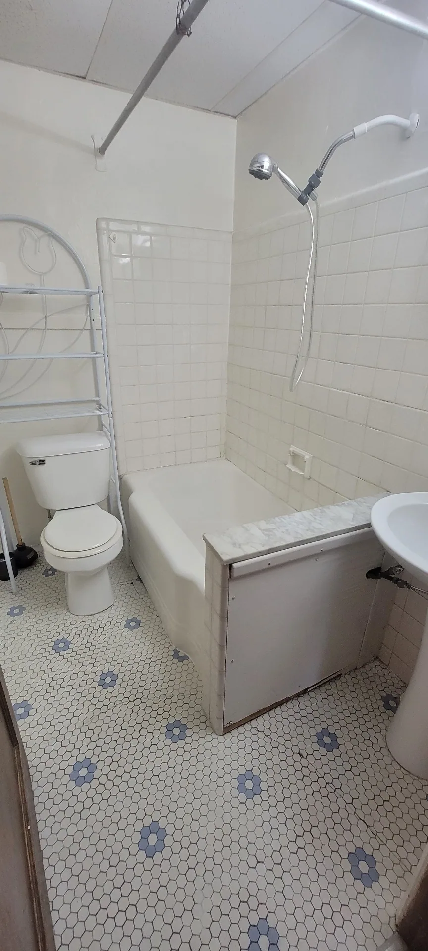 2054 Iuka Ave. A full bathroom with tub/shower, subway tile surround, and vintage hex tile floor