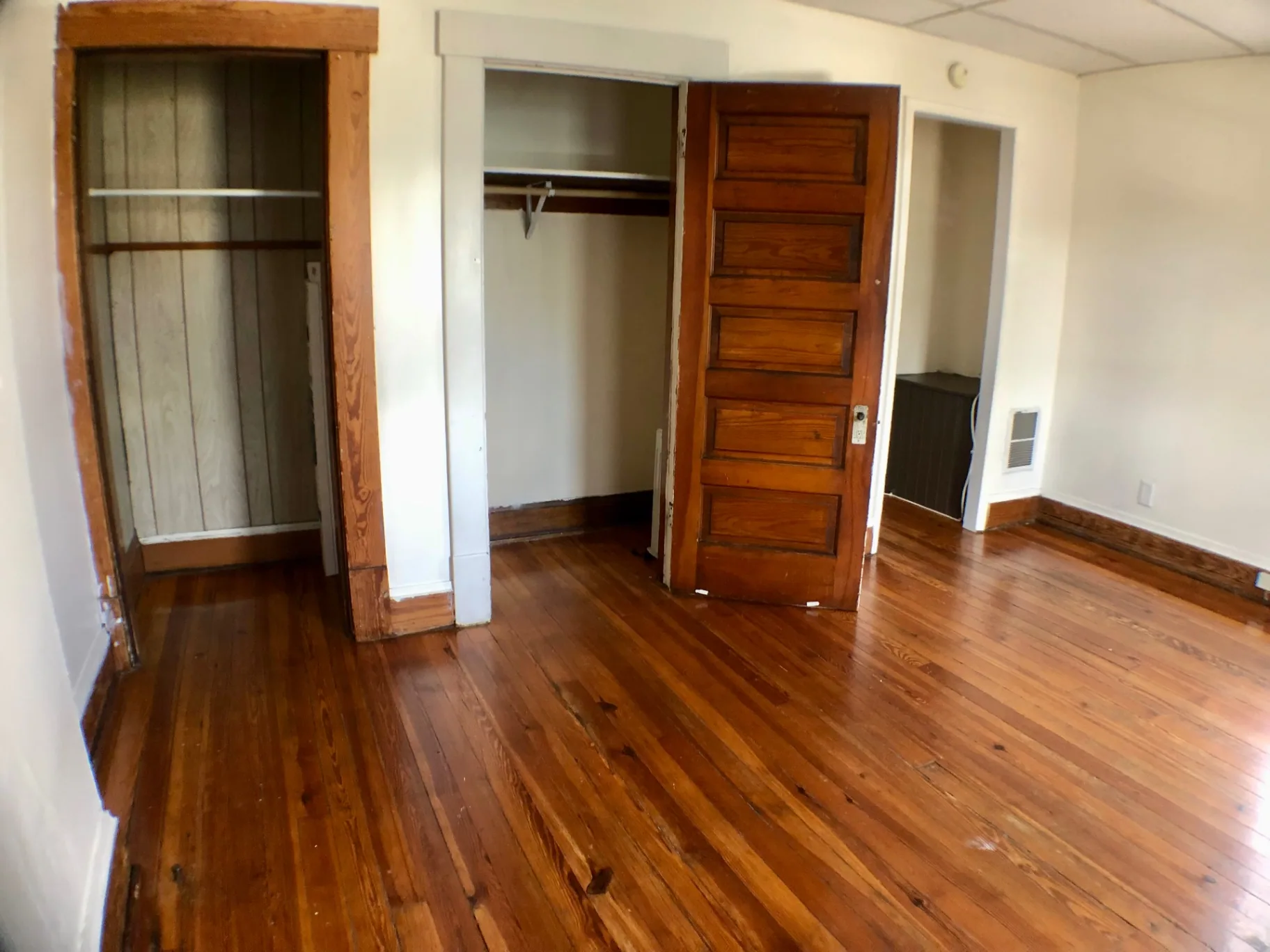 89 E Woodruff Ave. Unit A open closet with hanging rod and hardwood floors