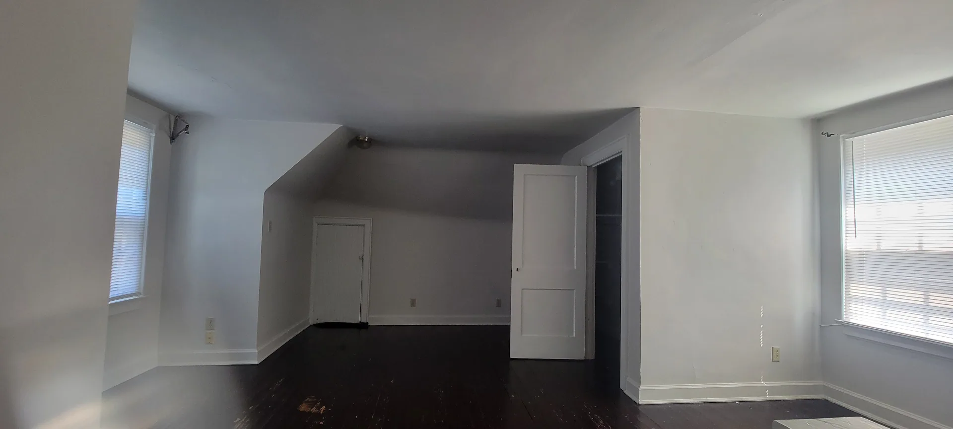 2044 Iuka Ave. C upper-level bonus room with dark-stained floors, dormer ceiling, and closet