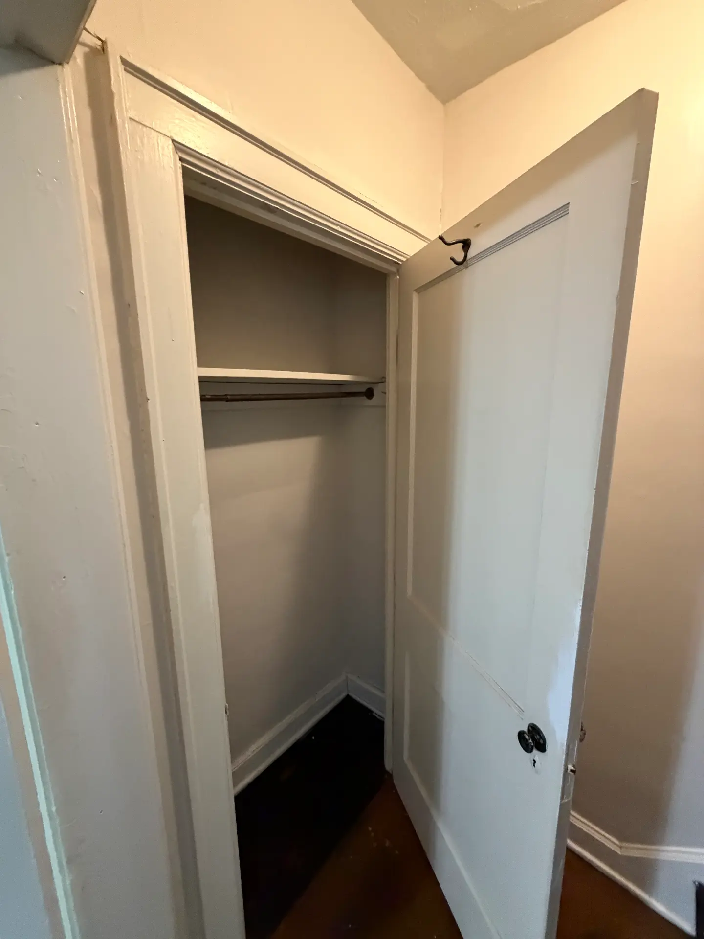 2048 Iuka Ave. D hallway closet with hanging rod and paneled wood door