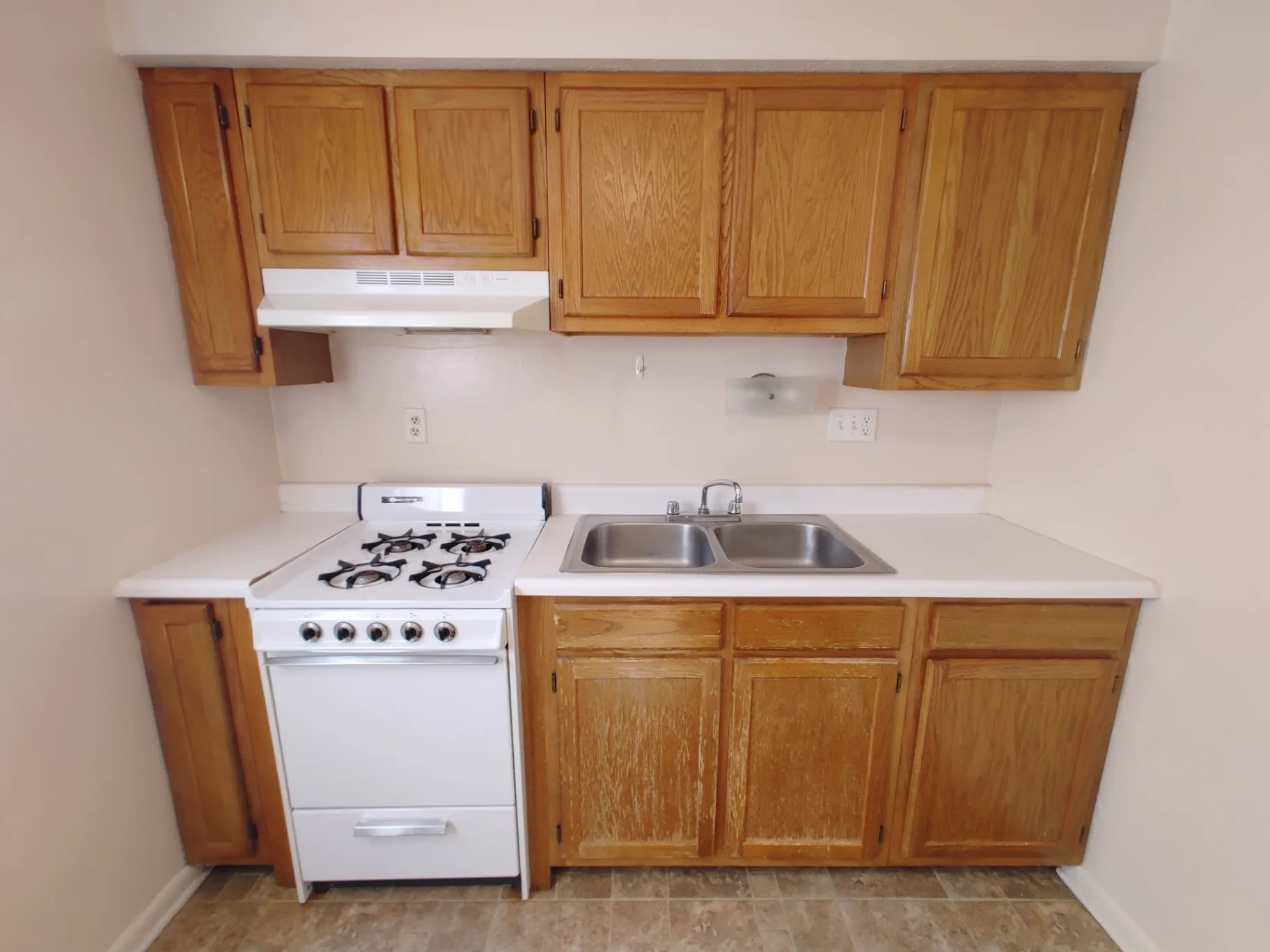2150 N 4th St. Unit B kitchen with double sink, gas range, and oak cabinets