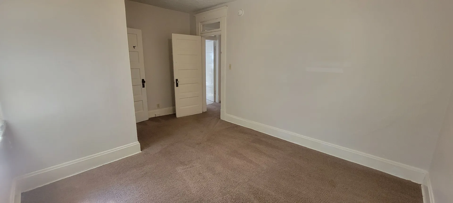 2015 Summit St. carpeted bedroom with original doors and hallway access