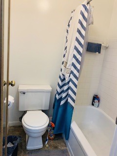 2026 Summit St. bathroom with tub/shower, tile surround, and toilet
