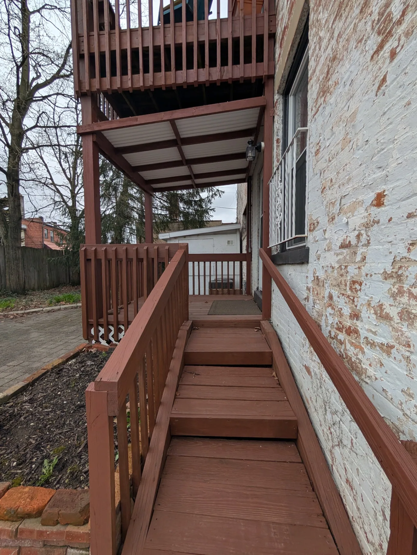 3338 Chestnut covered back entry ramp leading to the downstairs unit door