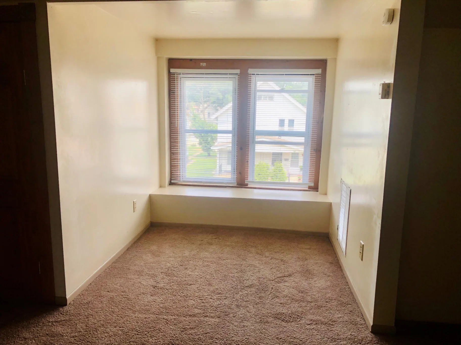77 E Patterson Ave. carpeted bedroom with large window looking out over the neighborhood