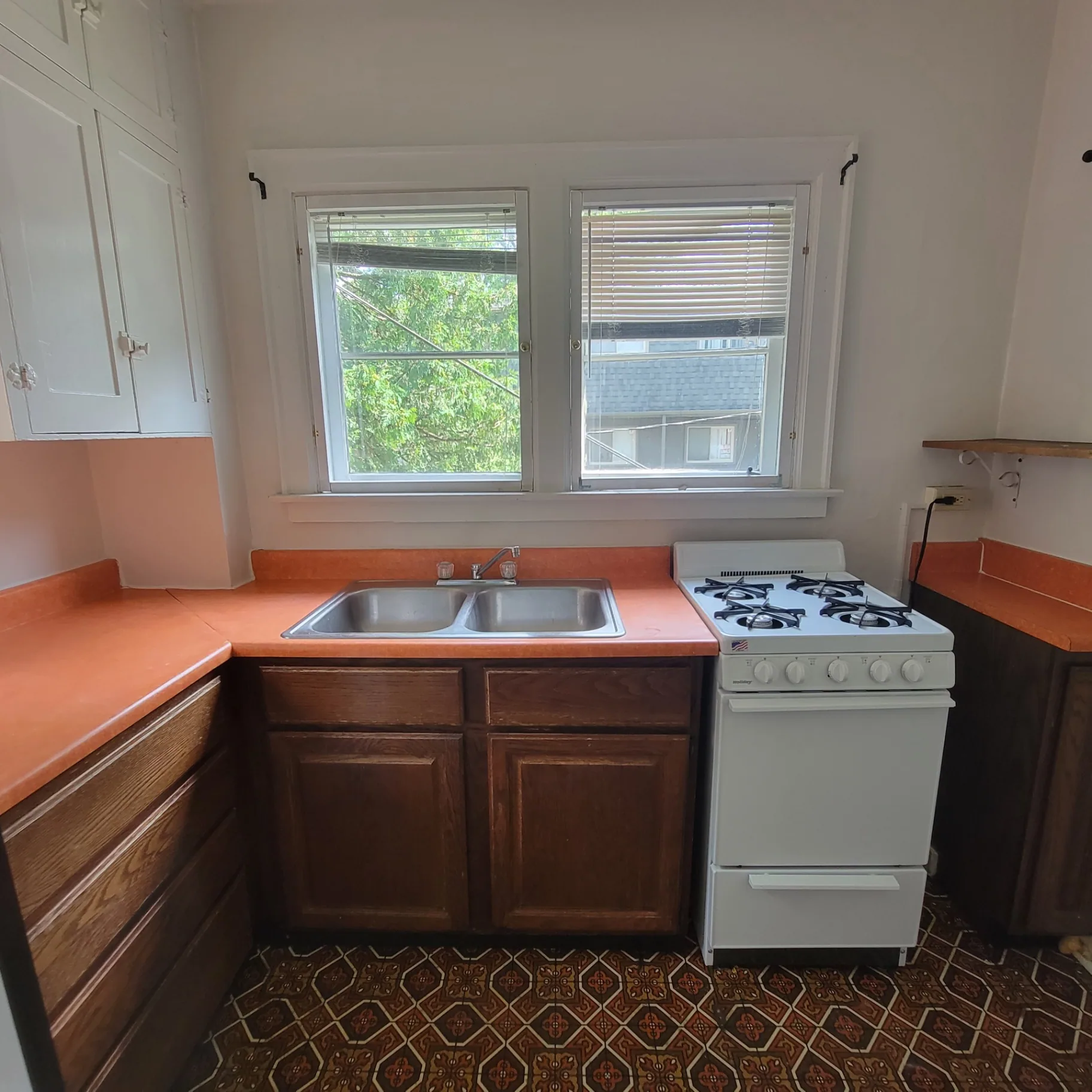 2048 Iuka Ave. C kitchen with double sink, gas range, and vintage patterned flooring