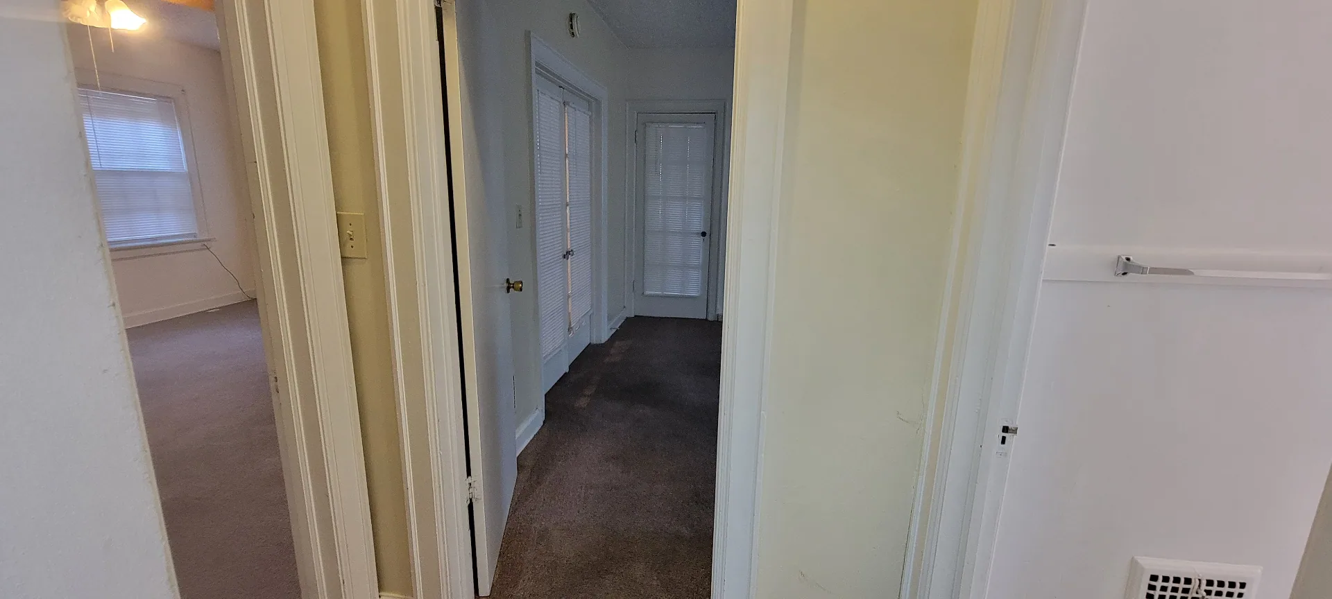 2044 Iuka Ave. D interior hallway with original wood doors leading to the bedrooms and bath