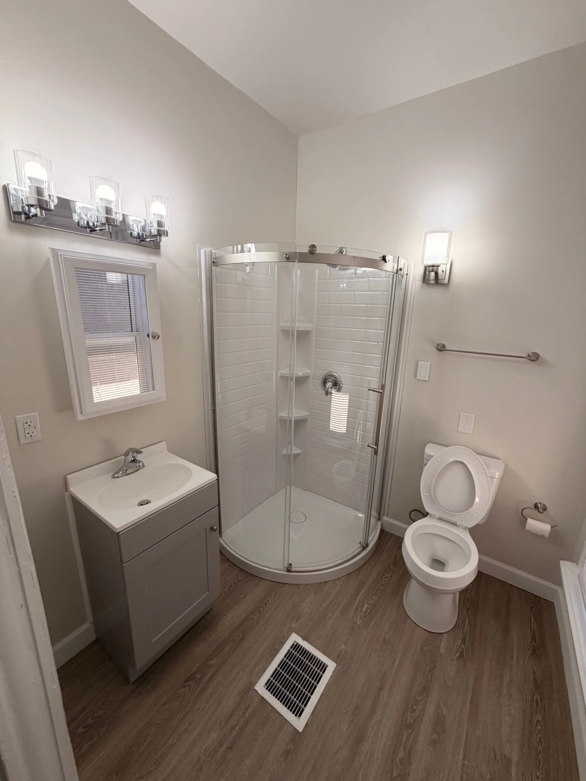 133½ updated bathroom with rounded glass shower, new vanity and chrome fixtures