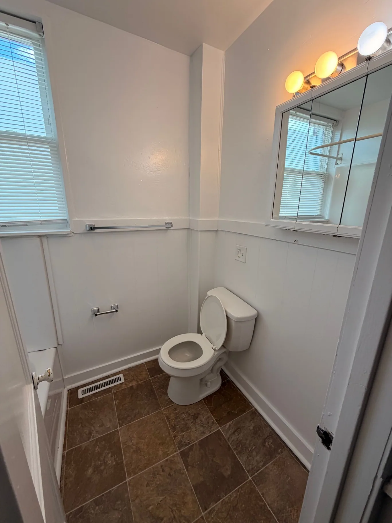 3340 Chestnut Upstairs second bathroom with wainscoting and window