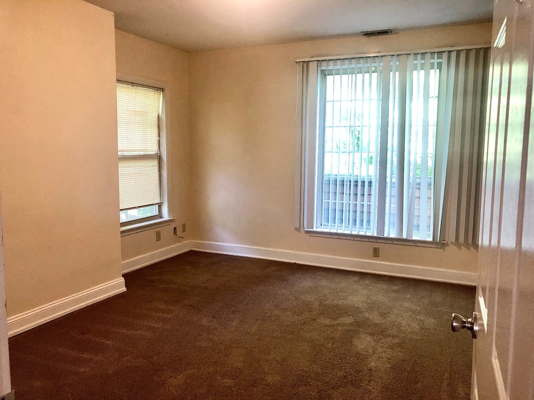 2034 Iuka Ave A carpeted bedroom with large windows