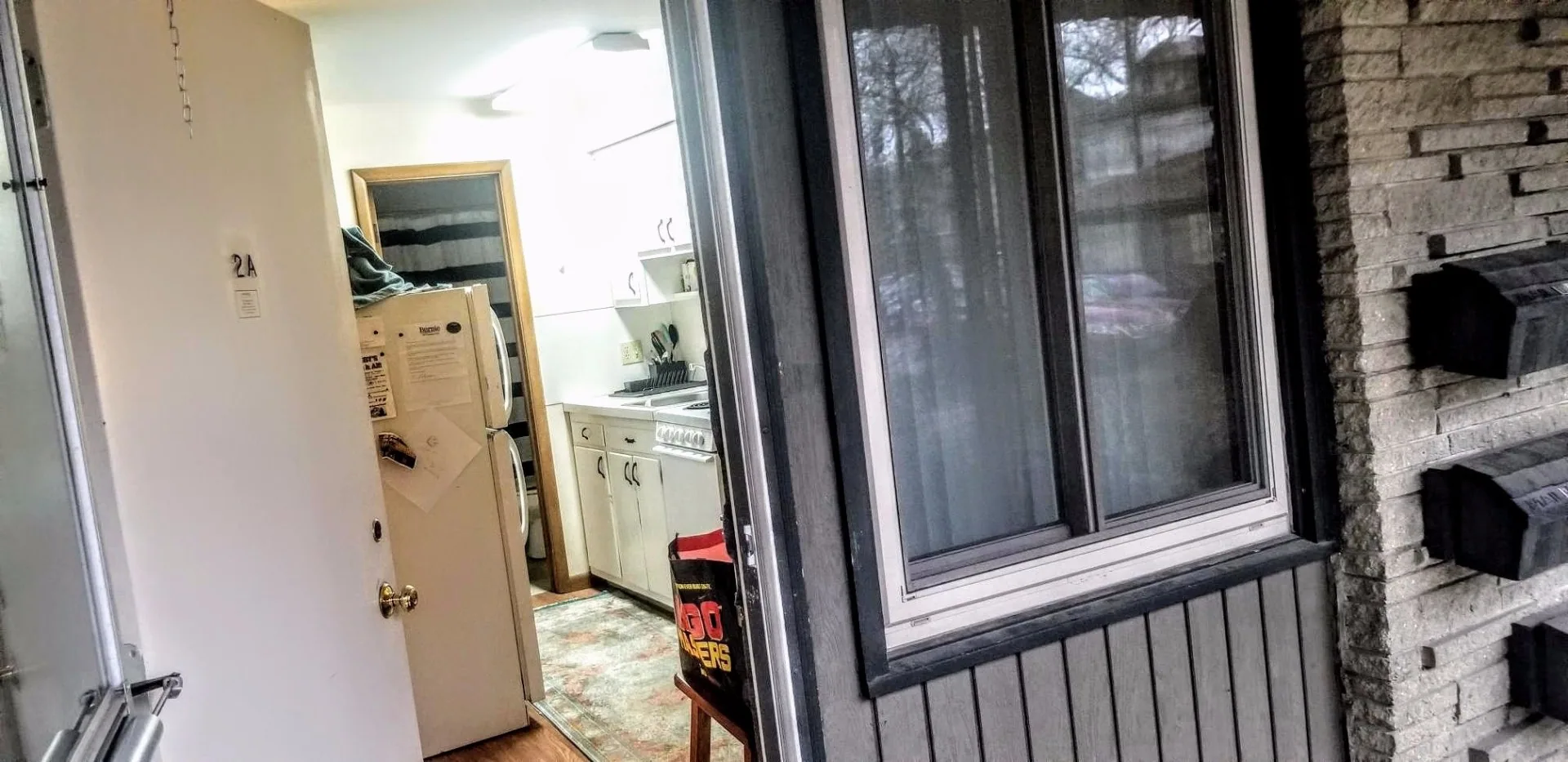 2040 Iuka Ave. 2A private entry door with view into kitchen and stacked washer/dryer