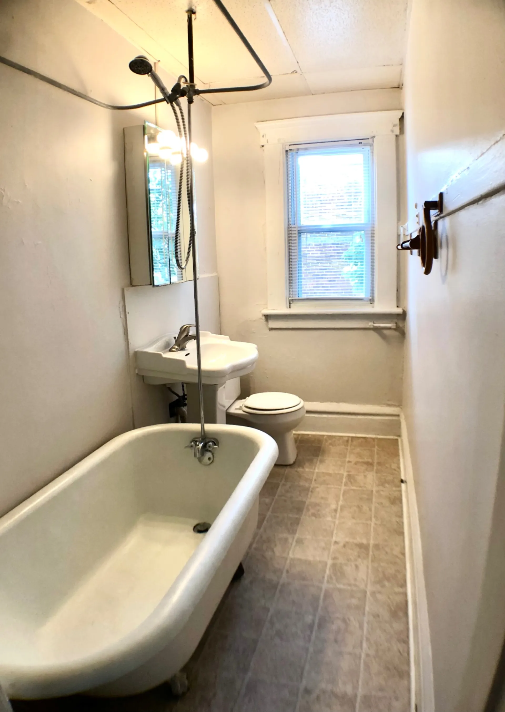 117 W 9th bathroom with original clawfoot tub and pedestal sink