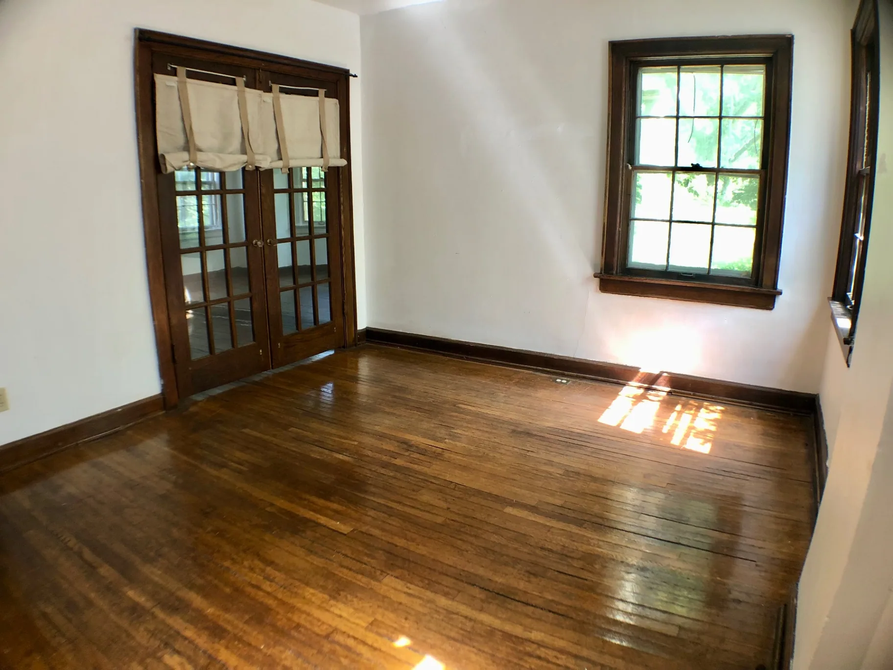 2044 Iuka Ave. A room with original French doors and hardwood floors
