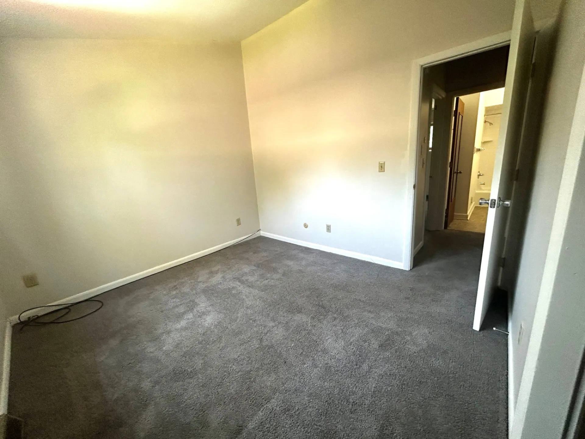 2011 Summit St. Unit E first bedroom with open doorway toward the hall