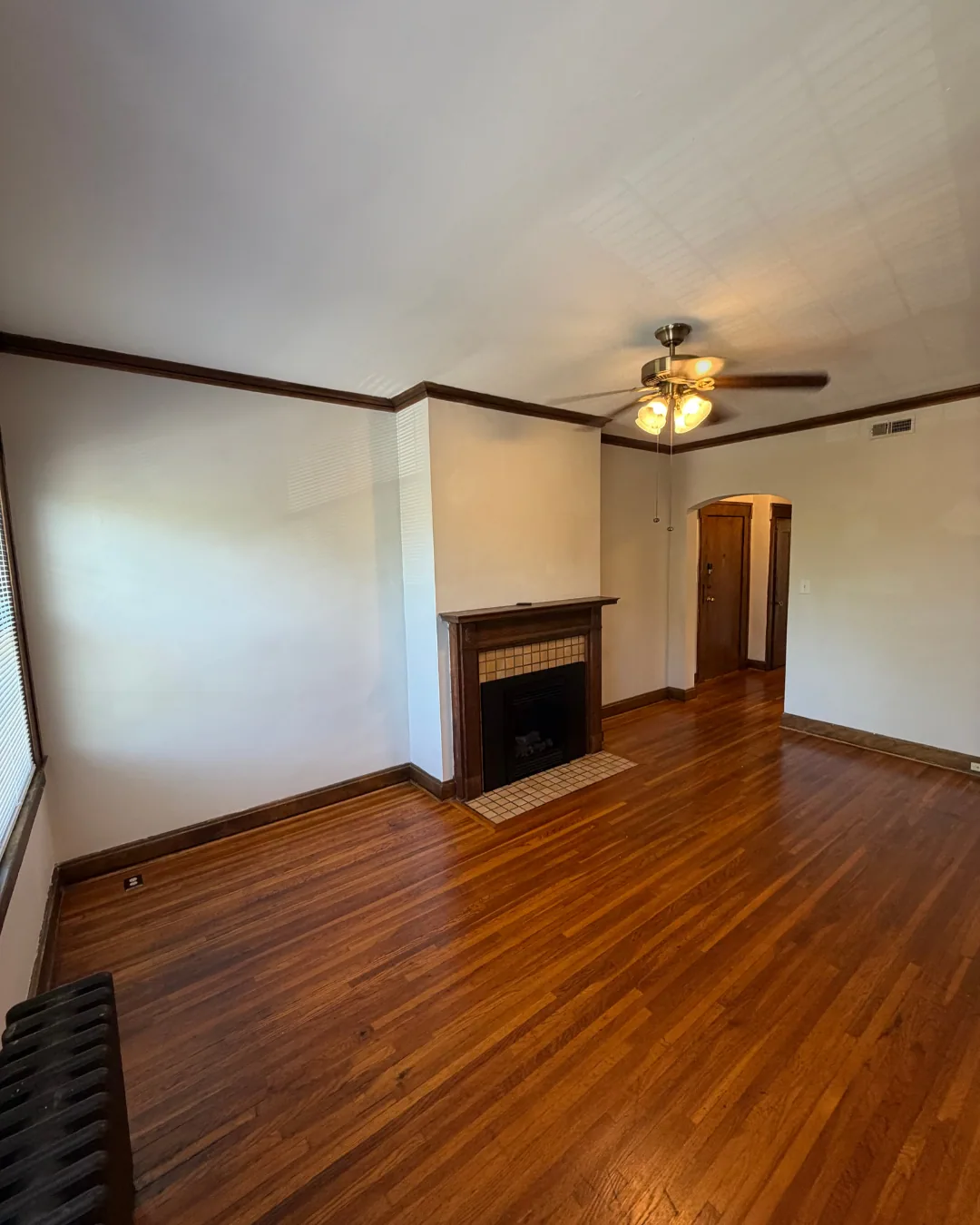 Spacious living room with tiled fireplace and natural light