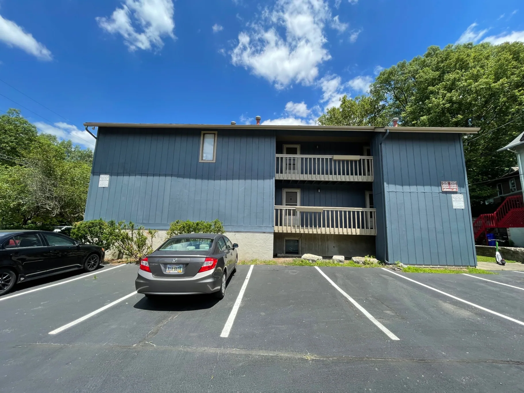 2020 Summit St. exterior with dedicated off-street parking spots at the rear of the building