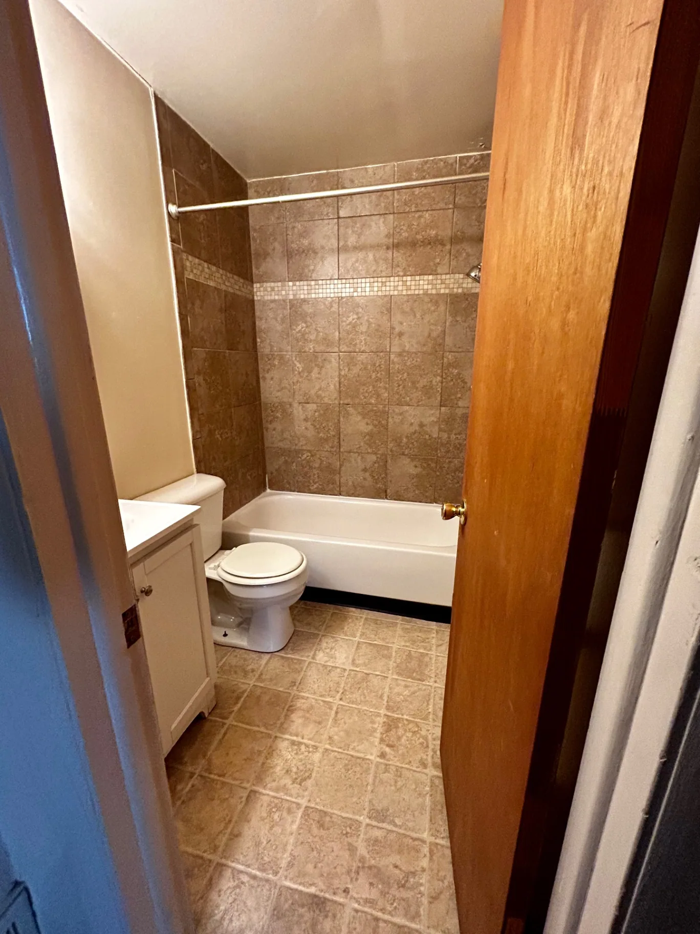 2150 N 4th St. Unit B bathroom with tiled tub surround and white vanity