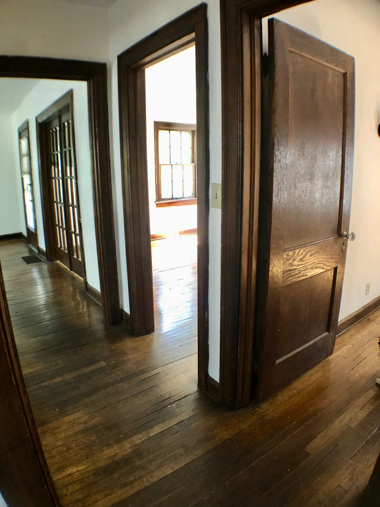 2044 Iuka Ave. A hallway view with original woodwork, glass-paneled doors, and connected rooms