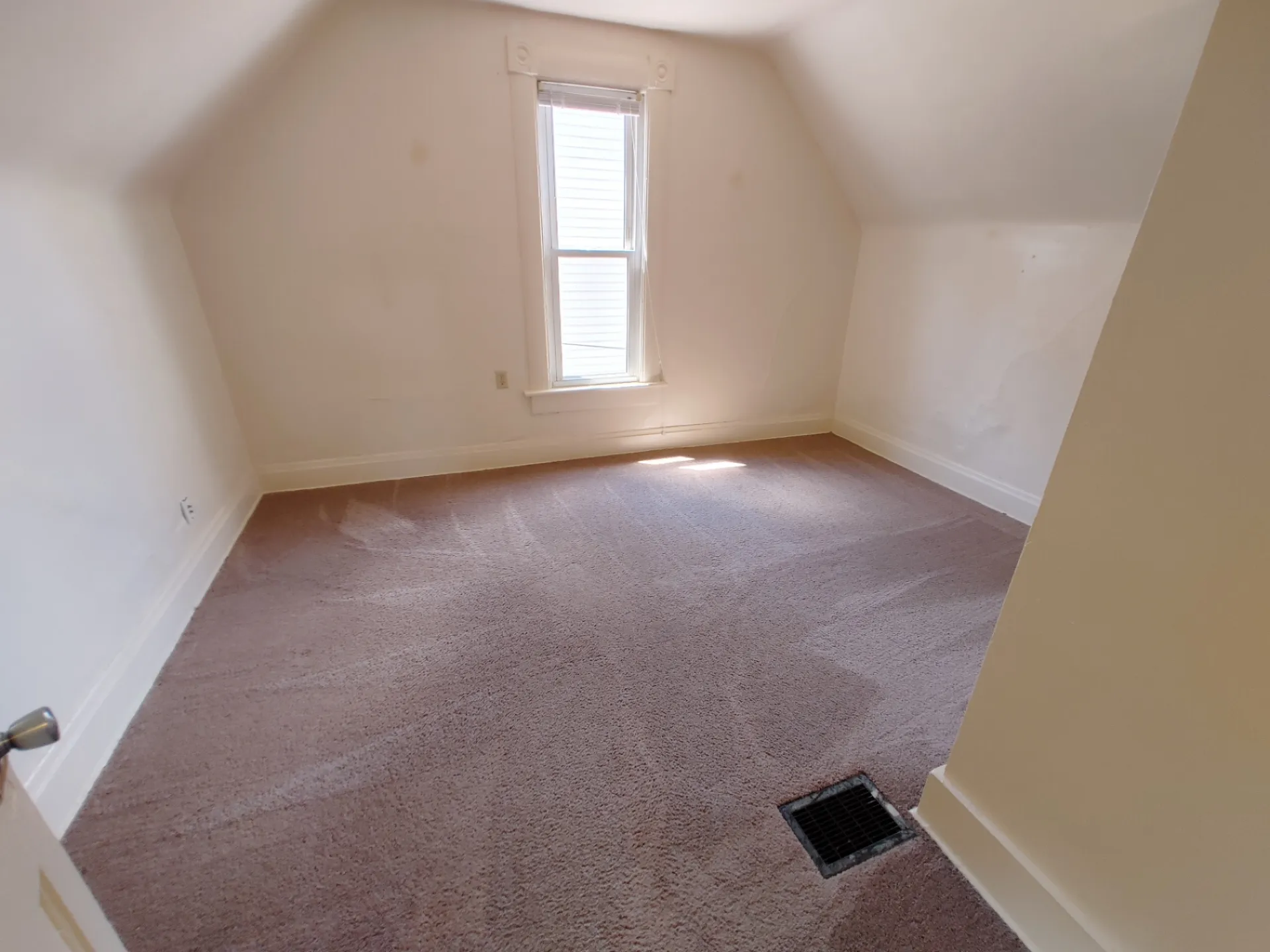 Rear unit upstairs bedroom with vaulted ceiling and fresh carpet