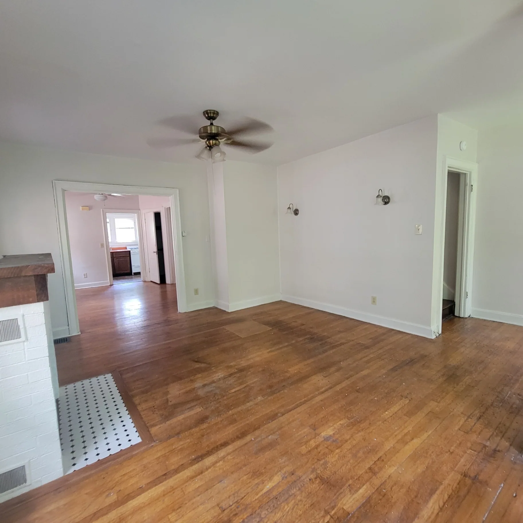 2048 Iuka Ave. C living room view toward kitchen with wall sconces and ceiling fan