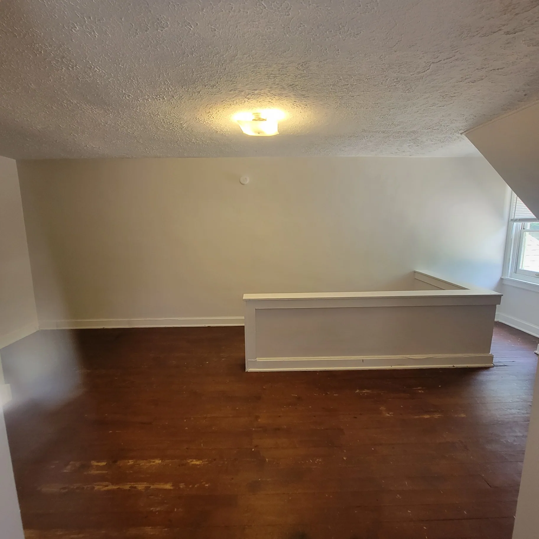 2048 Iuka Ave. C upstairs bedroom wide view with vaulted ceiling and hardwood floors