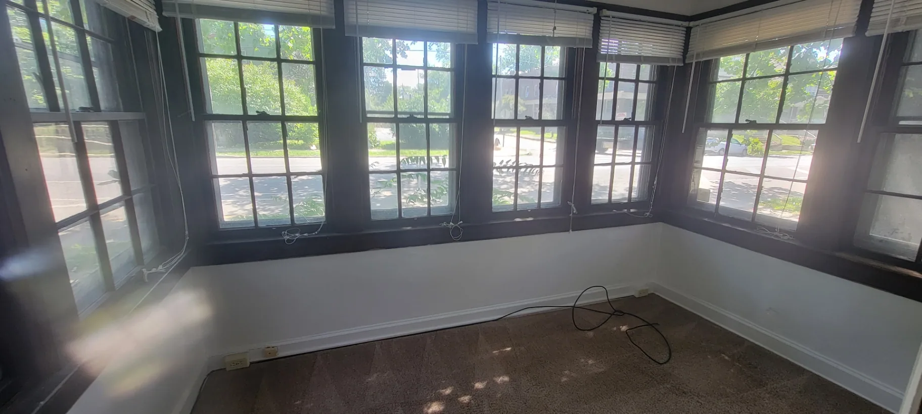 2054 Iuka Ave. A sunroom with wraparound windows overlooking the street