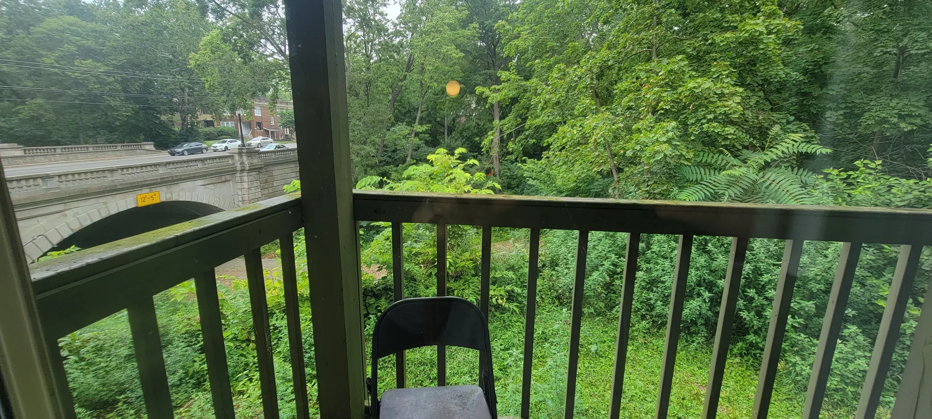2024 Summit St. covered balcony overlooking the bridge and lush Iuka Ravine greenery