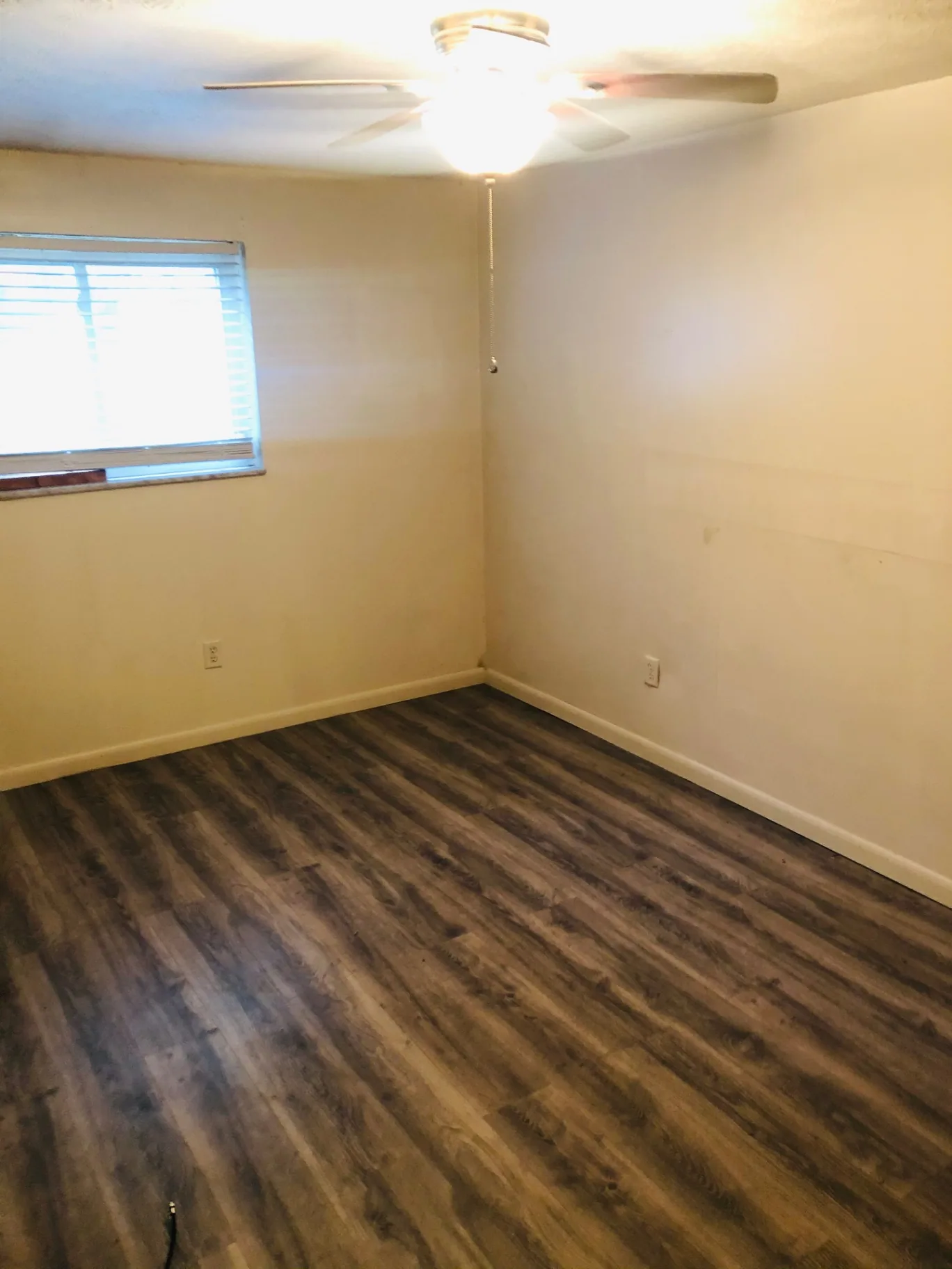 2150 N 4th St. Unit A bedroom with ceiling fan and wood-look flooring