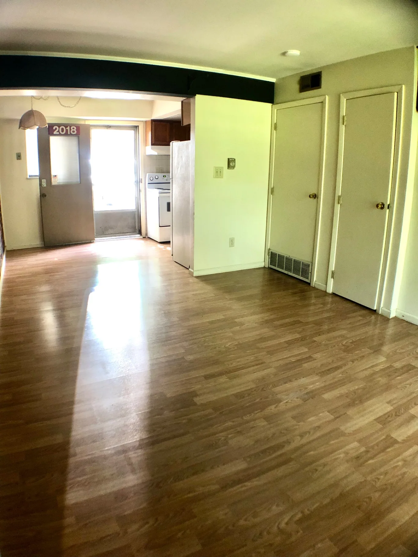 2018 Iuka Ave. open living room with wood floors, staircase, and view into the kitchen