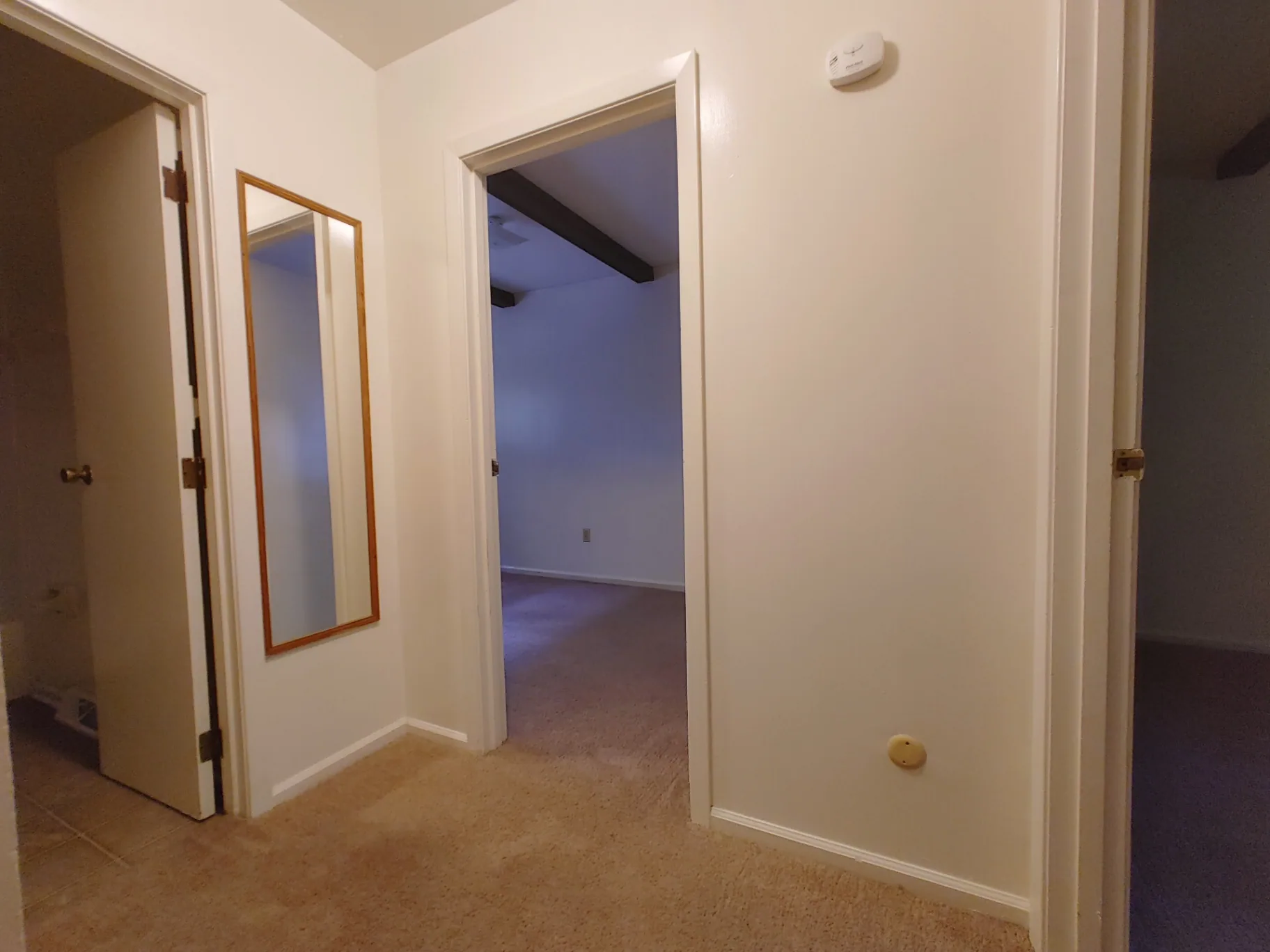 2018 Iuka Ave. upper hallway with mirror leading to bedrooms and bathroom