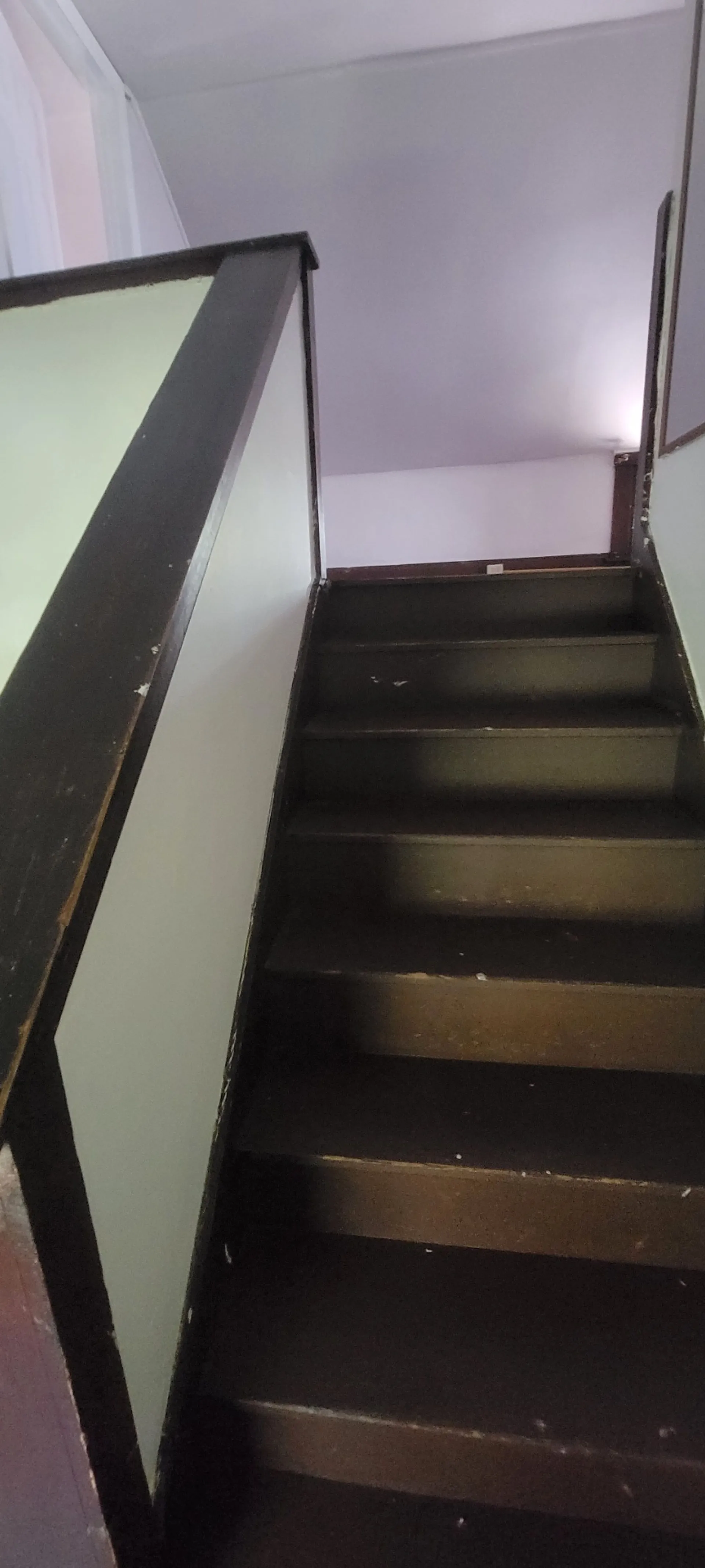 2015 Summit St. dark-stained wood staircase leading to the third floor