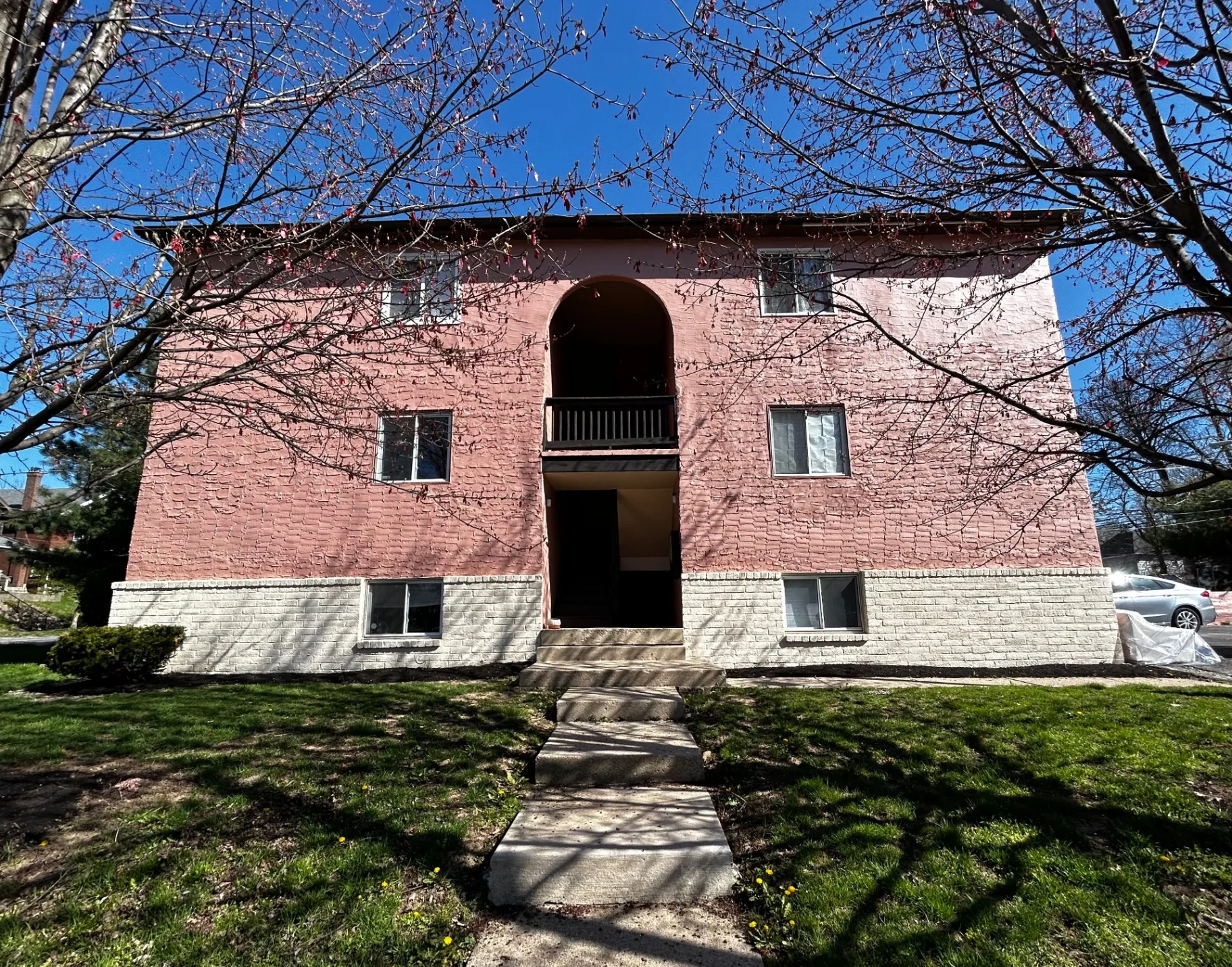 2150 N 4th St. Unit D front exterior of pink stucco building with arched entryway