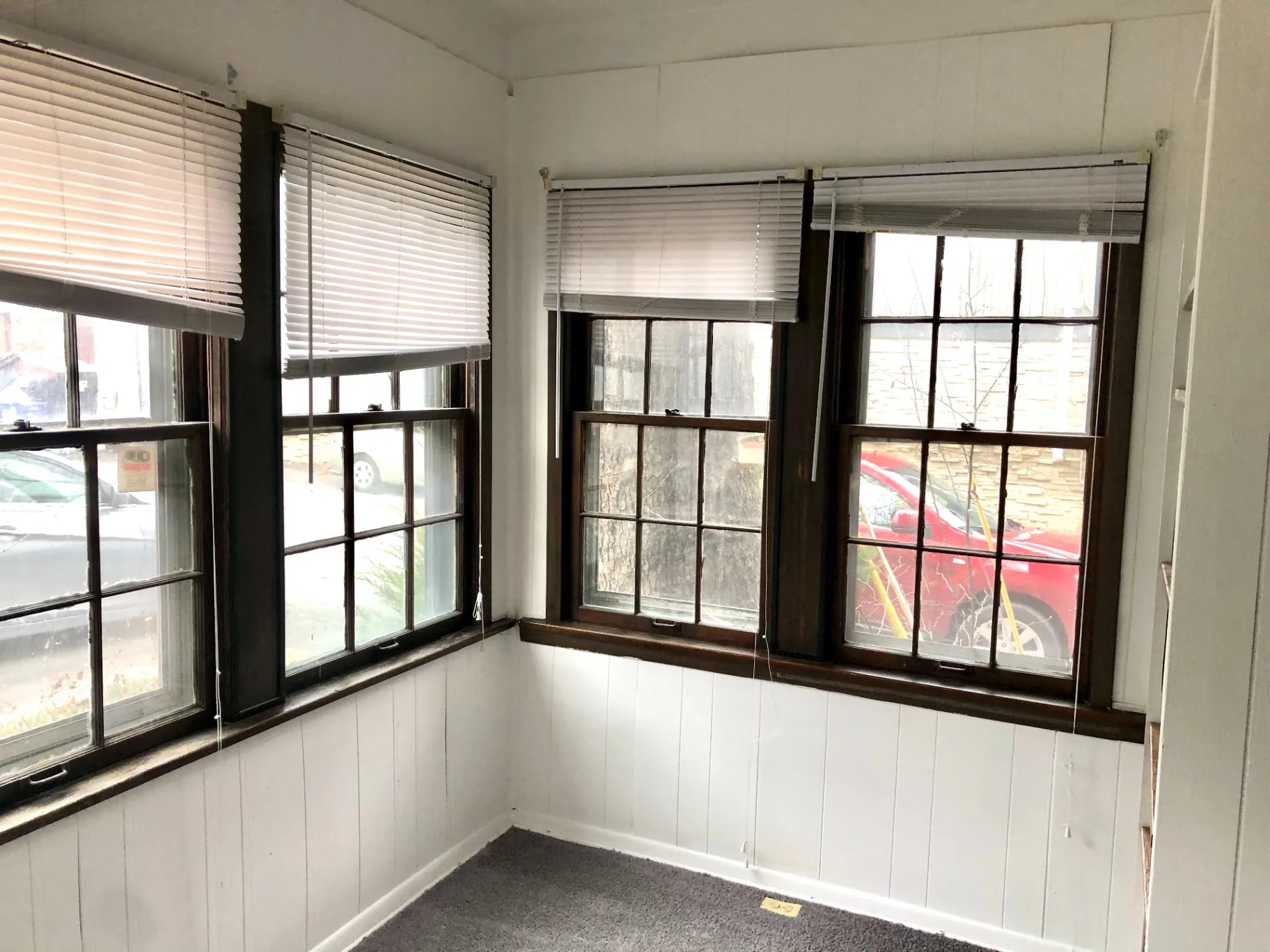 2044 Iuka Ave. B enclosed sunroom with wraparound wood-trim windows and street views