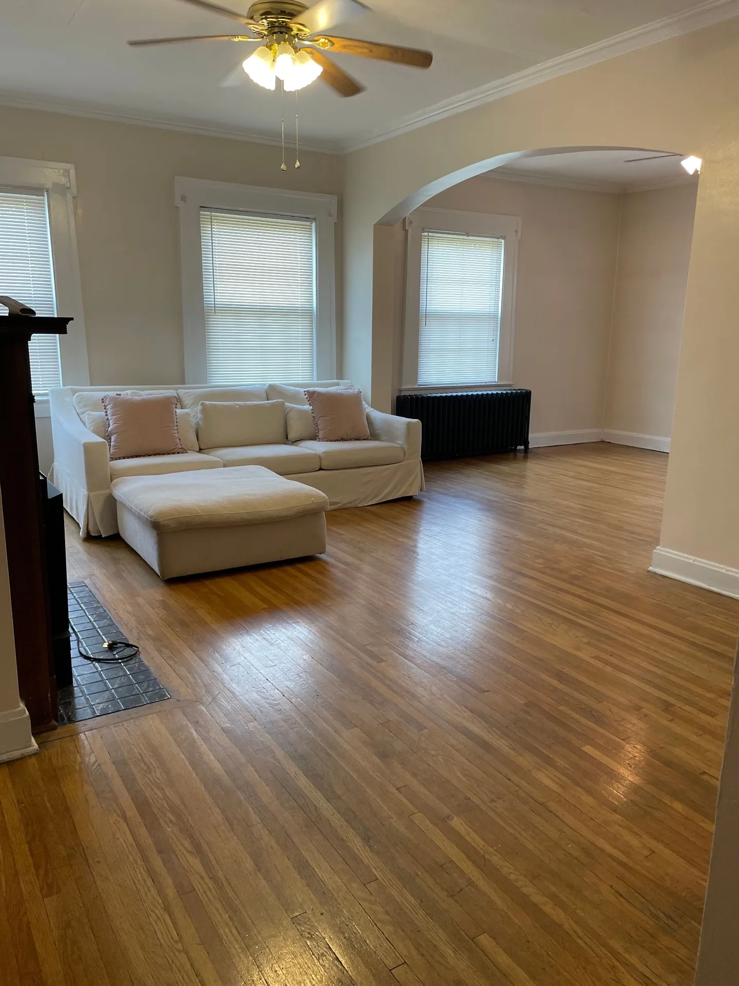 Unit E living room with open floor plan and arched entry
