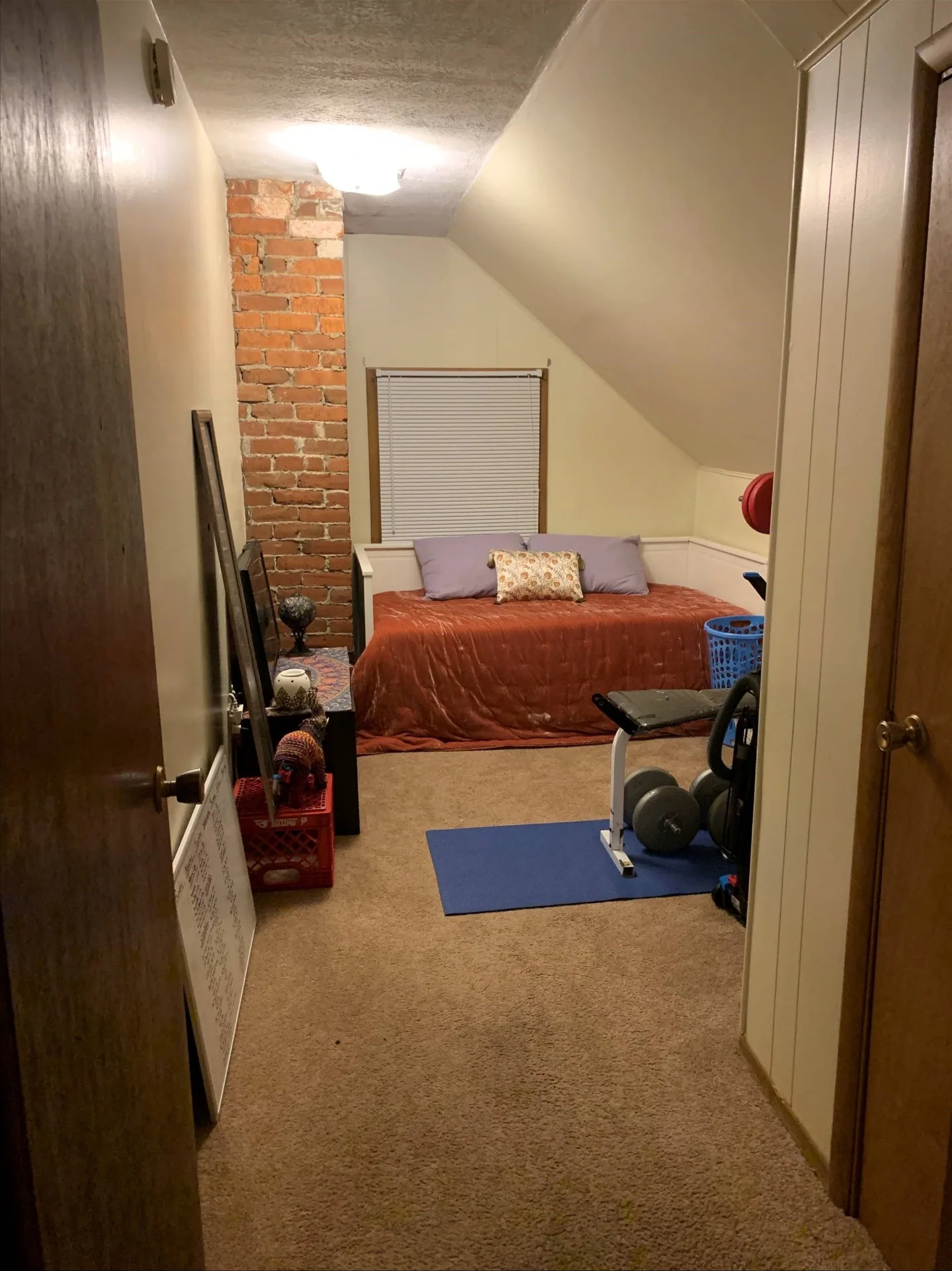 Flex room with exposed brick chimney, daybed, and window seating
