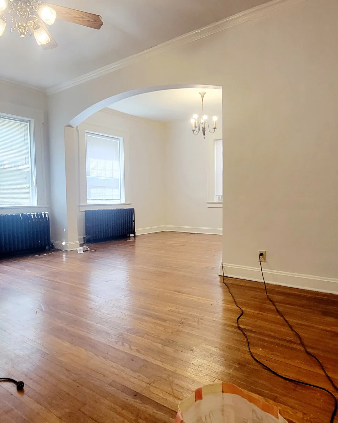 Unit A open living area with archway between rooms and chandelier