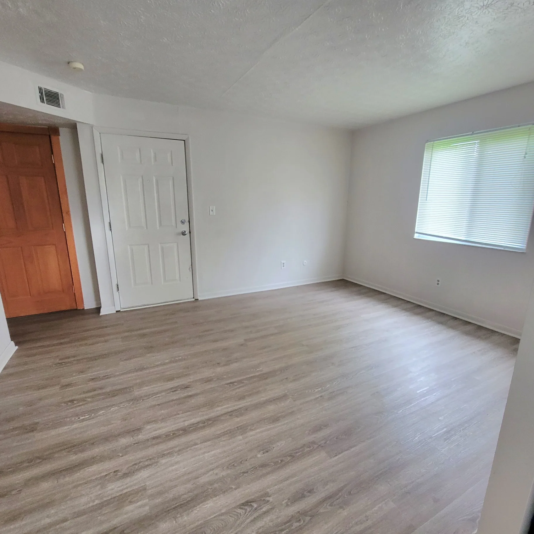 2150 N 4th St. Unit E entry and living area with plank flooring and bright window