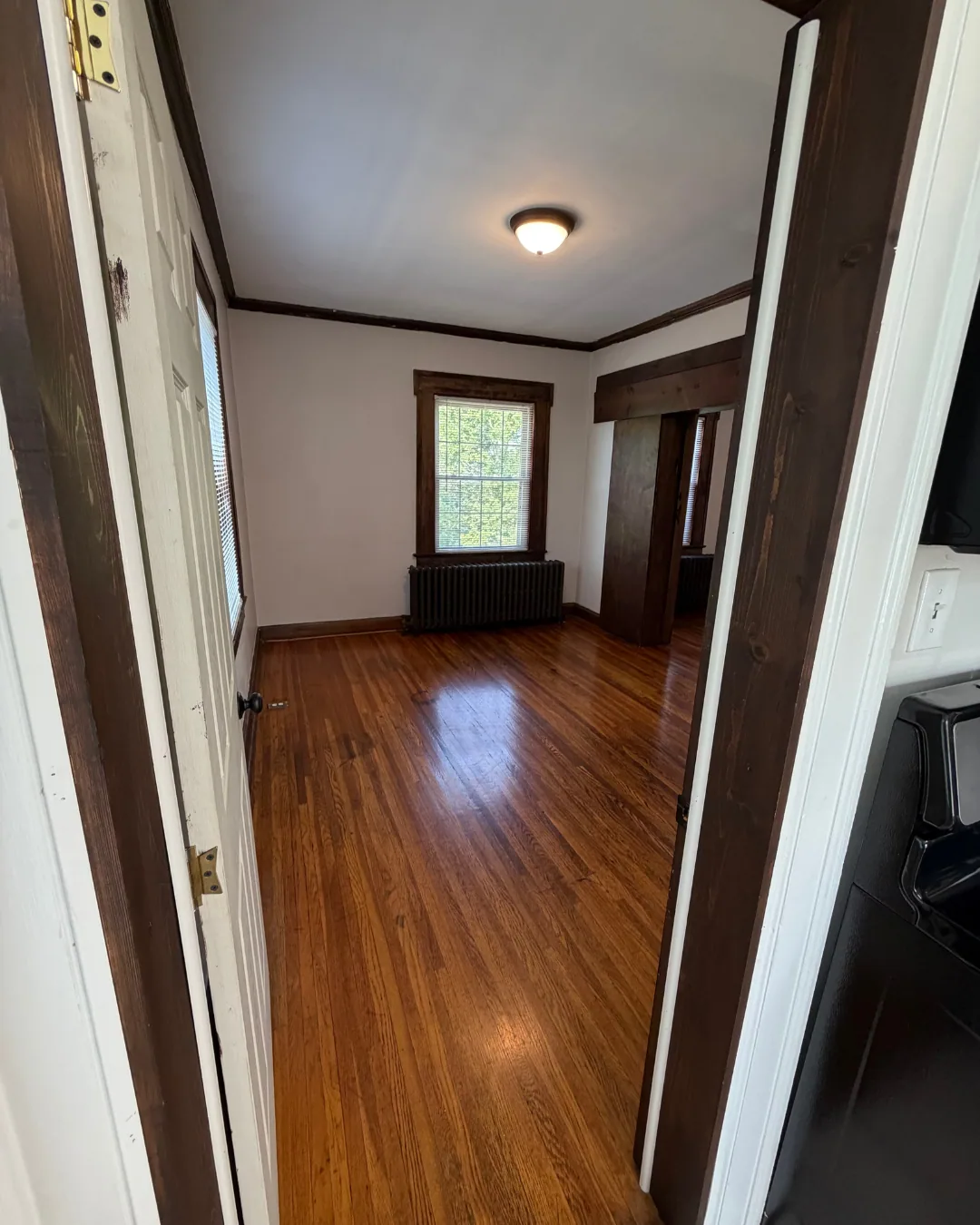 Bedroom entrance with dark wood trim and bright natural light