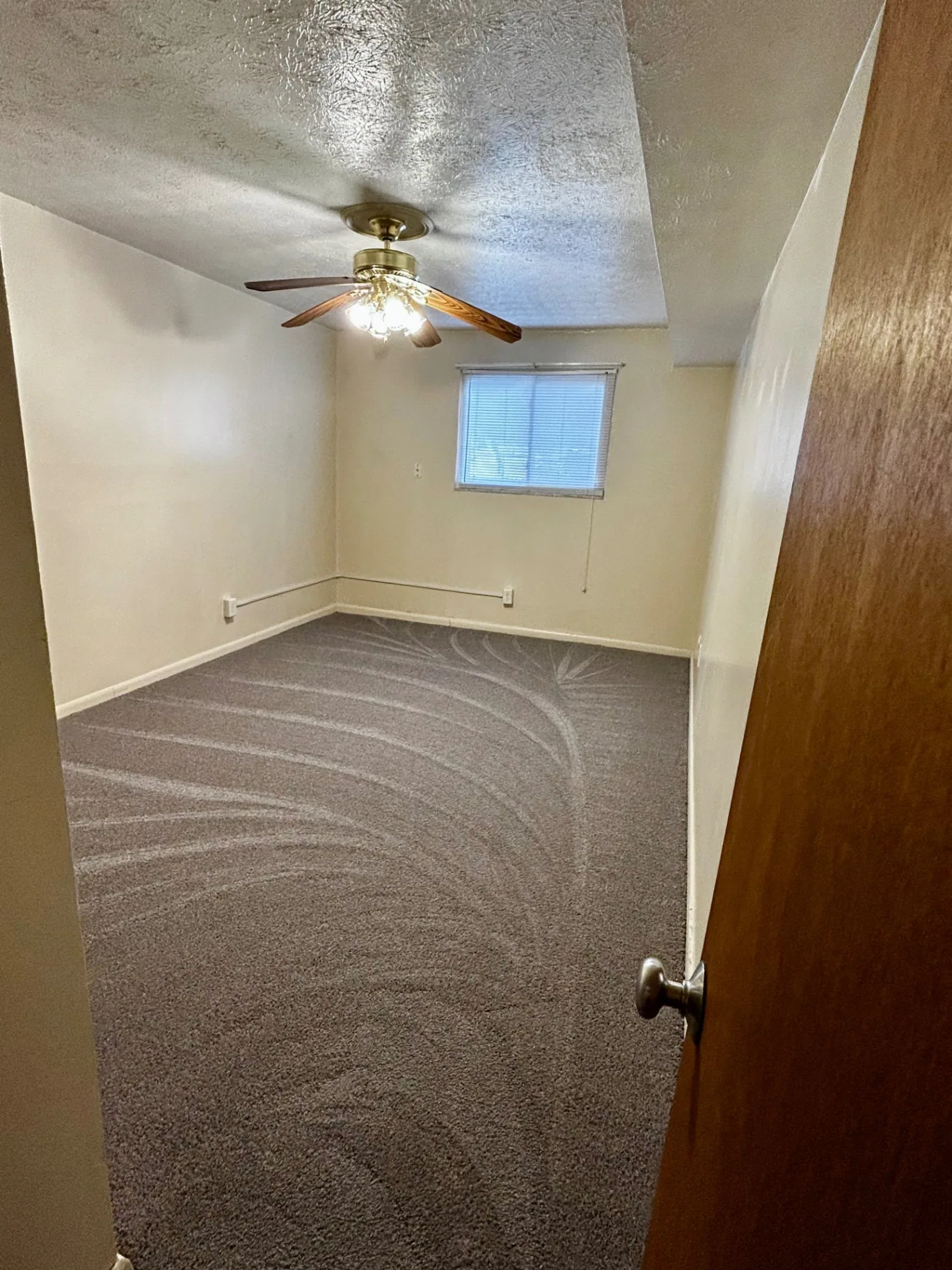 2150 N 4th St. Unit B carpeted bedroom with ceiling fan and window