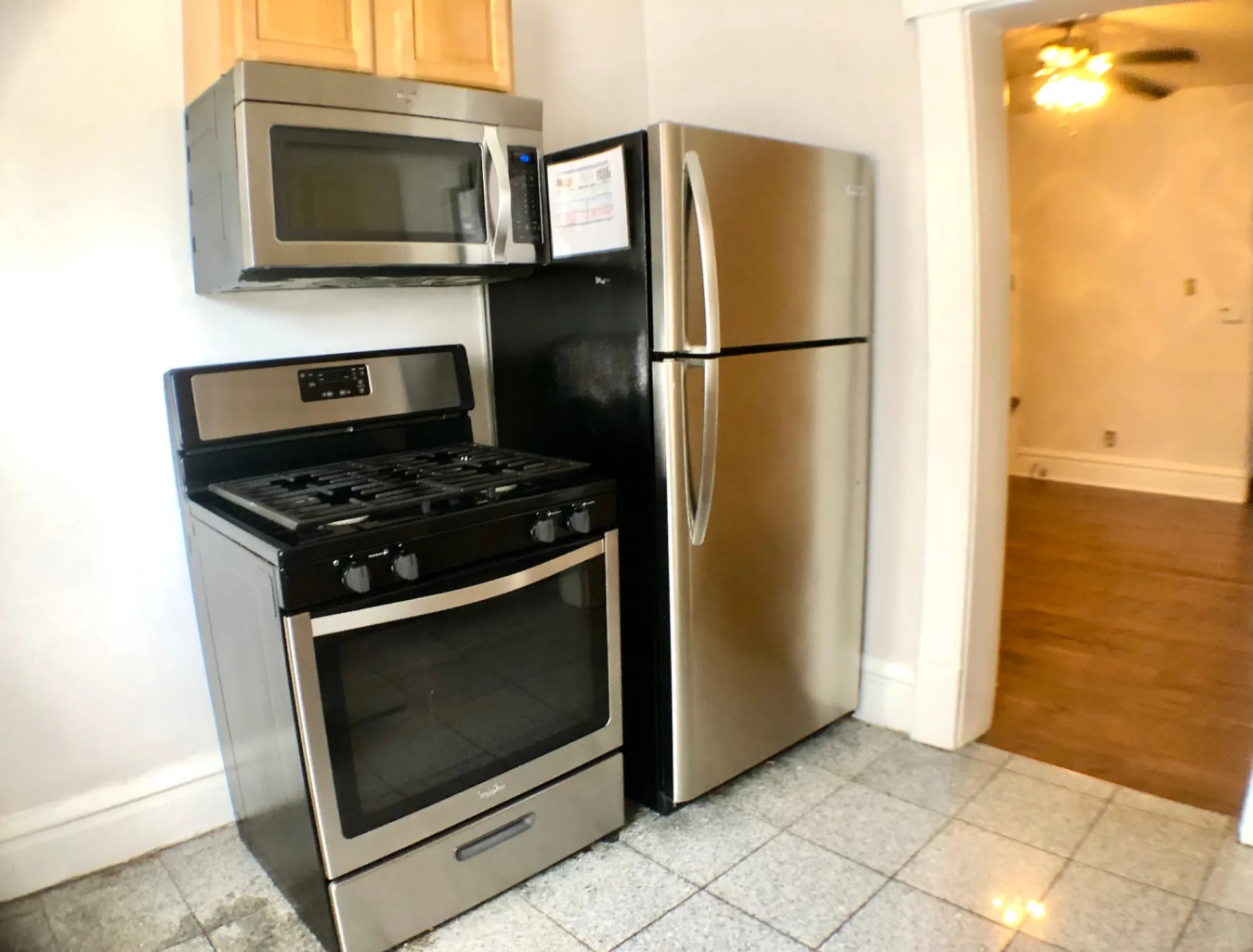117 W 9th kitchen with stainless steel gas range, microwave and refrigerator