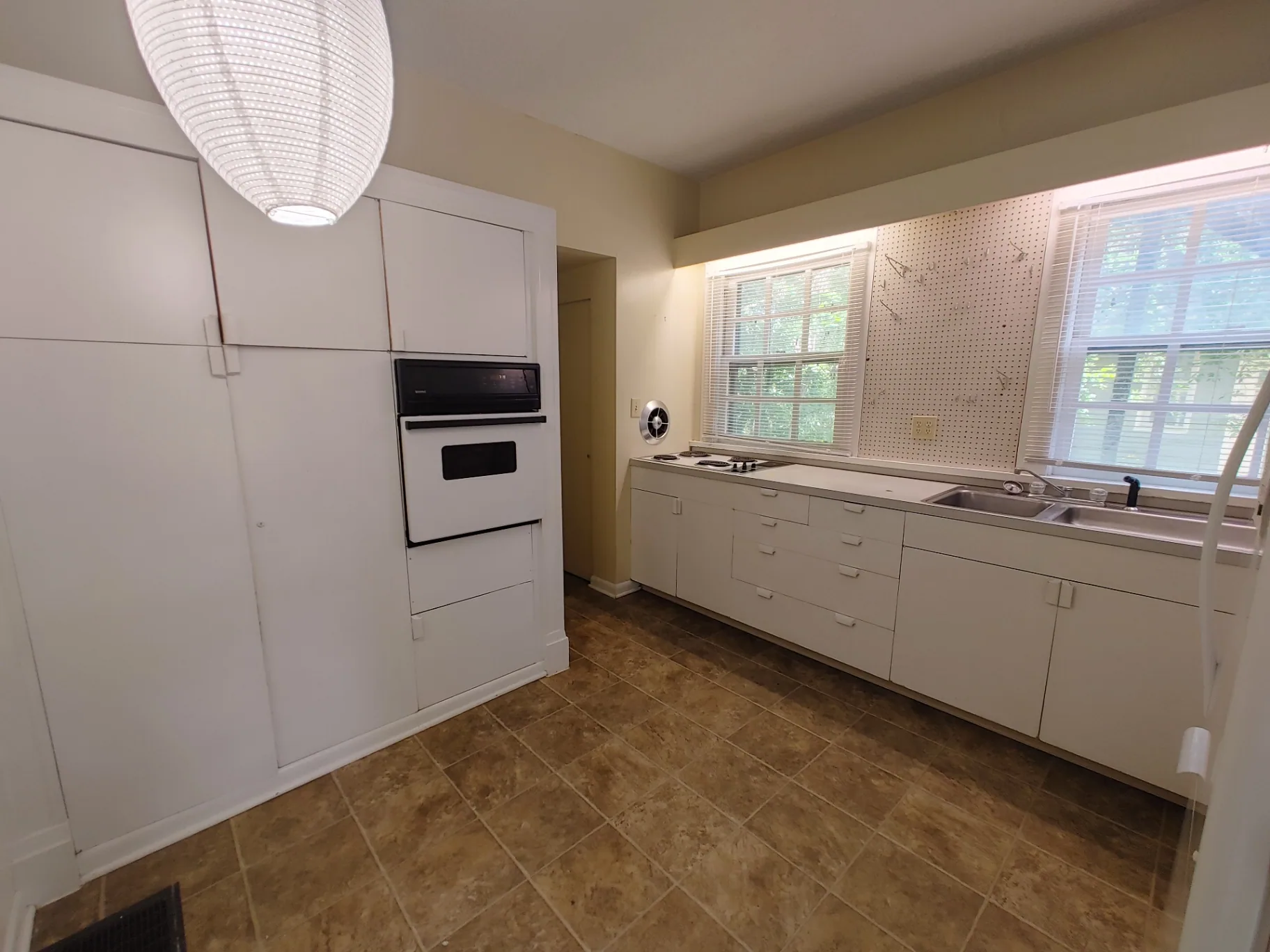 2026 Iuka Ave B eat-in kitchen with wall oven, cooktop, and double sink under bright windows