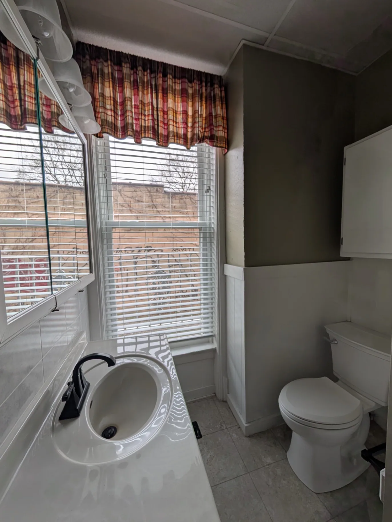 3338 Chestnut Downstairs bathroom with pedestal sink, toilet and bright windows