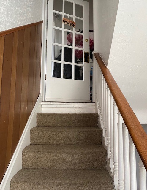 3340 Chestnut Upstairs stair landing with French-door style entry at the top of the stairs