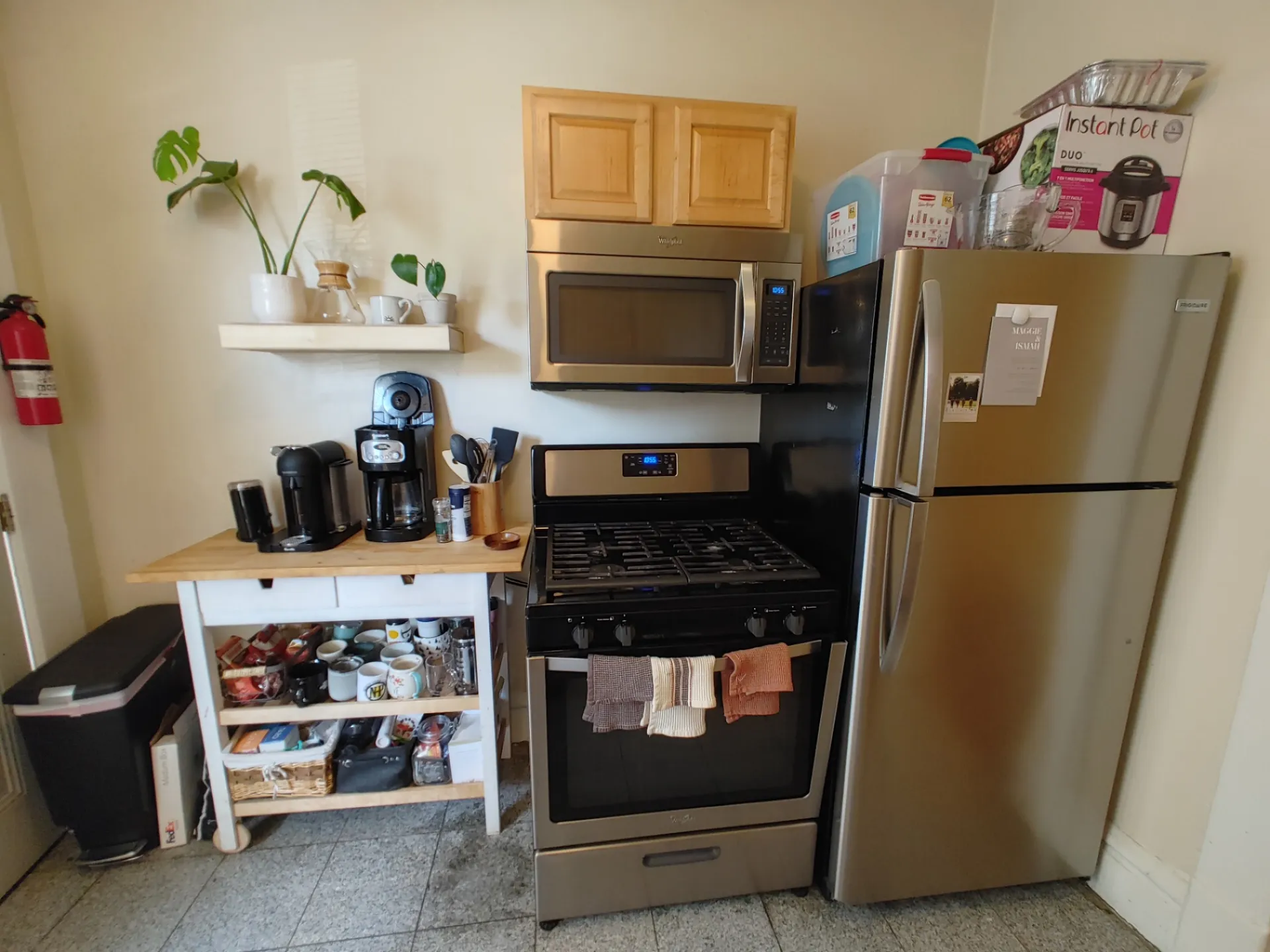 121 W 9th kitchen with stainless gas range, microwave, and refrigerator