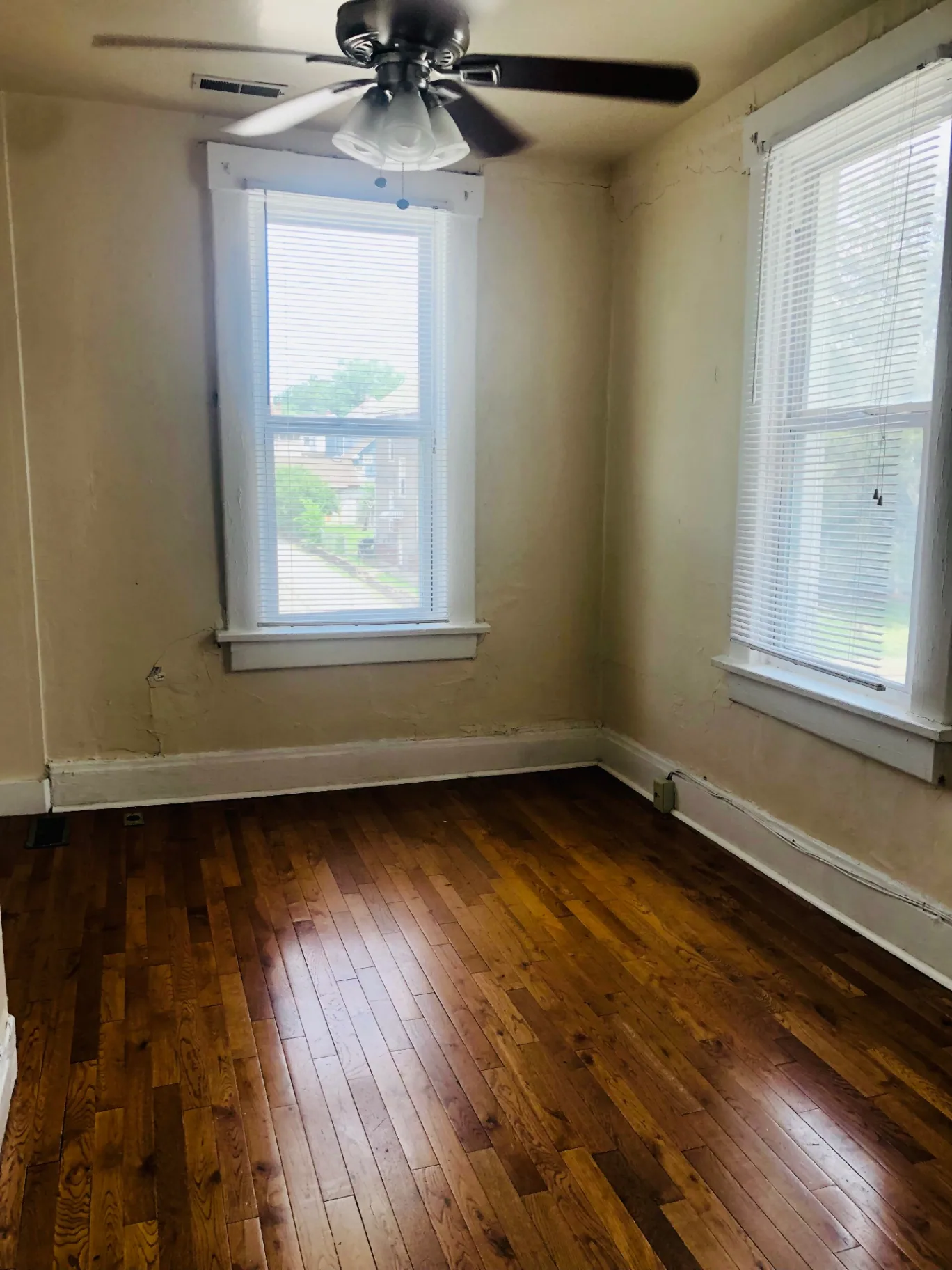 77 E Patterson Ave. bright room with refinished hardwood floors, two windows, and ceiling fan