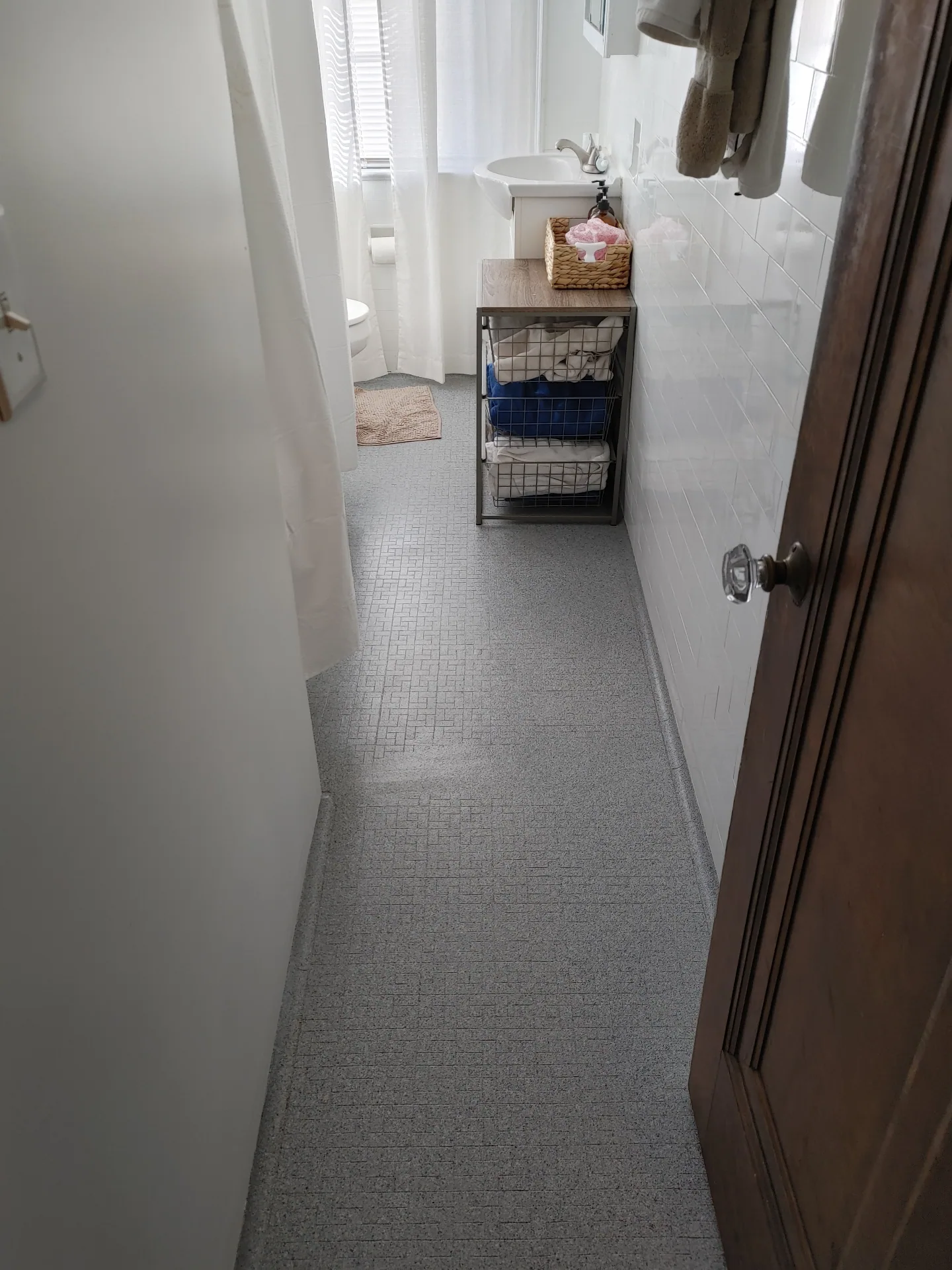 Unit G bathroom with tiled floor and subway tile walls