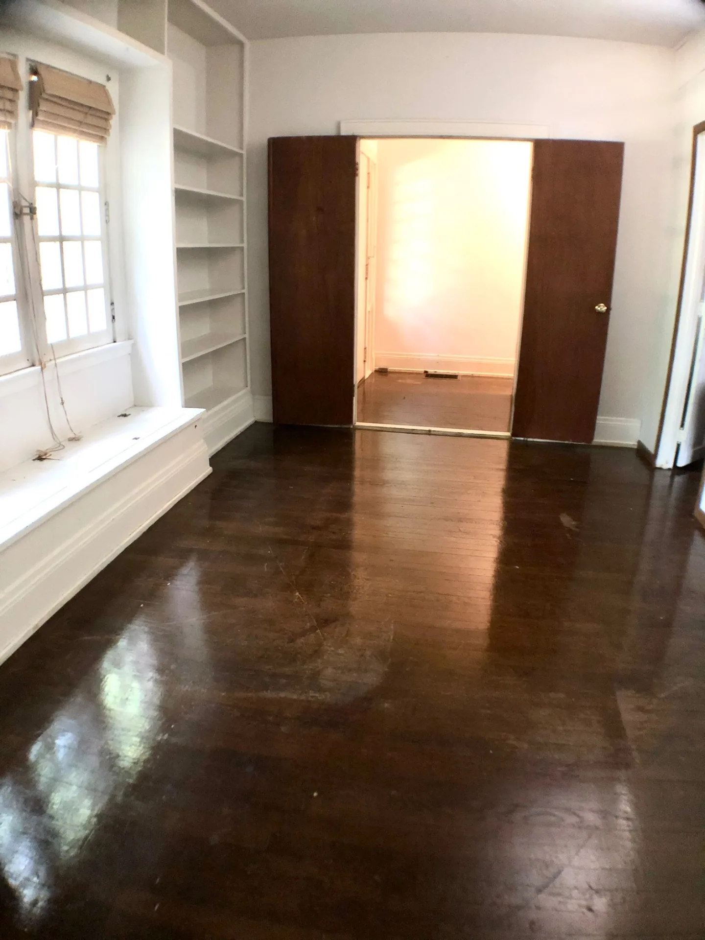 2026 Iuka Ave A bedroom with built-in bookshelves and pocket doors