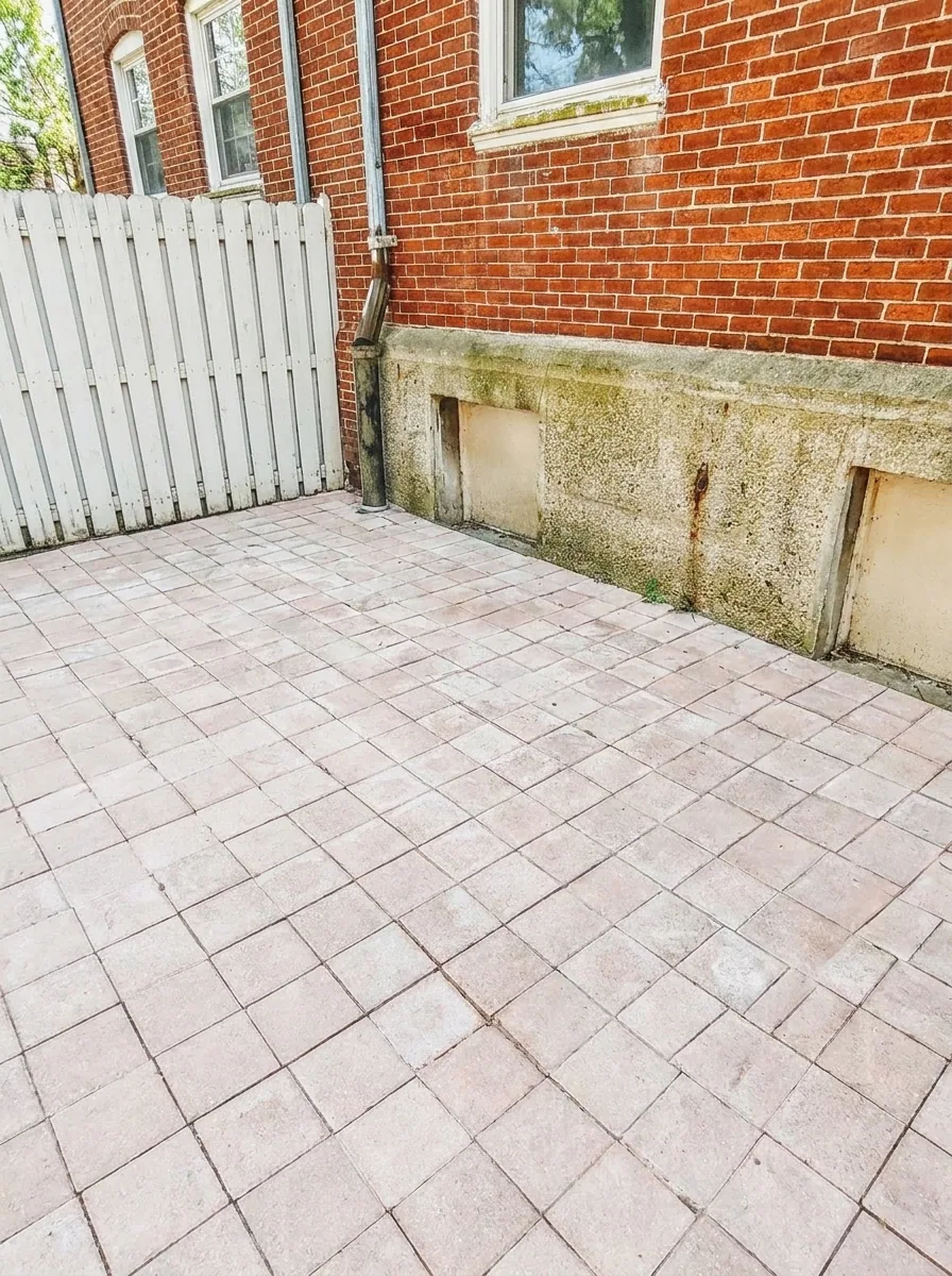 Unit D private paver patio with white privacy fence