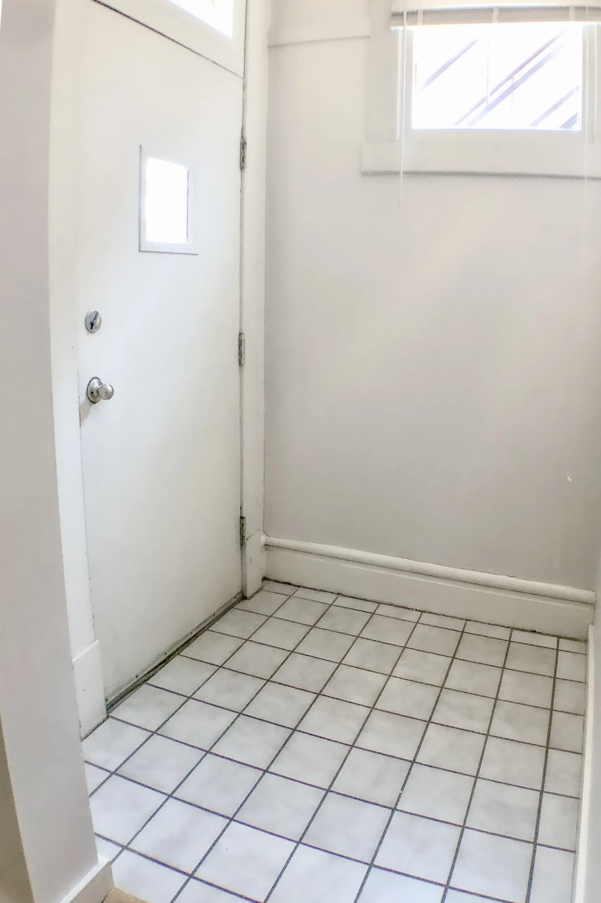 Unit A back entry with tile floor and private door